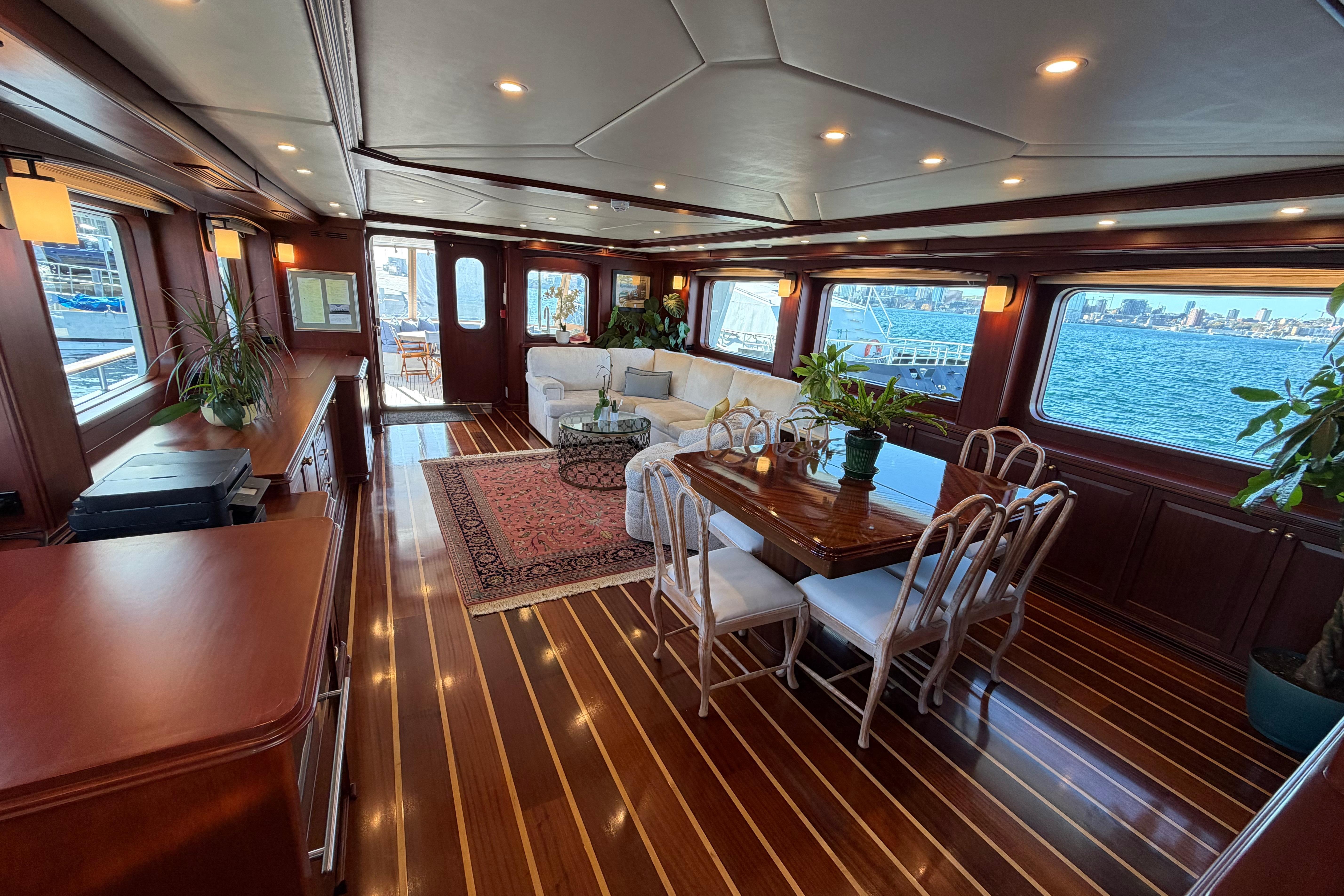 Luxurious yacht interior with elegant dining area, wooden flooring, and ocean view. Doogersbank Vipack 2001.