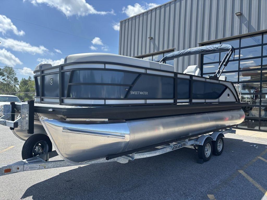 2026 Godfrey SWEETWATER 2286 SFL pontoon boat on trailer, parked outdoors.