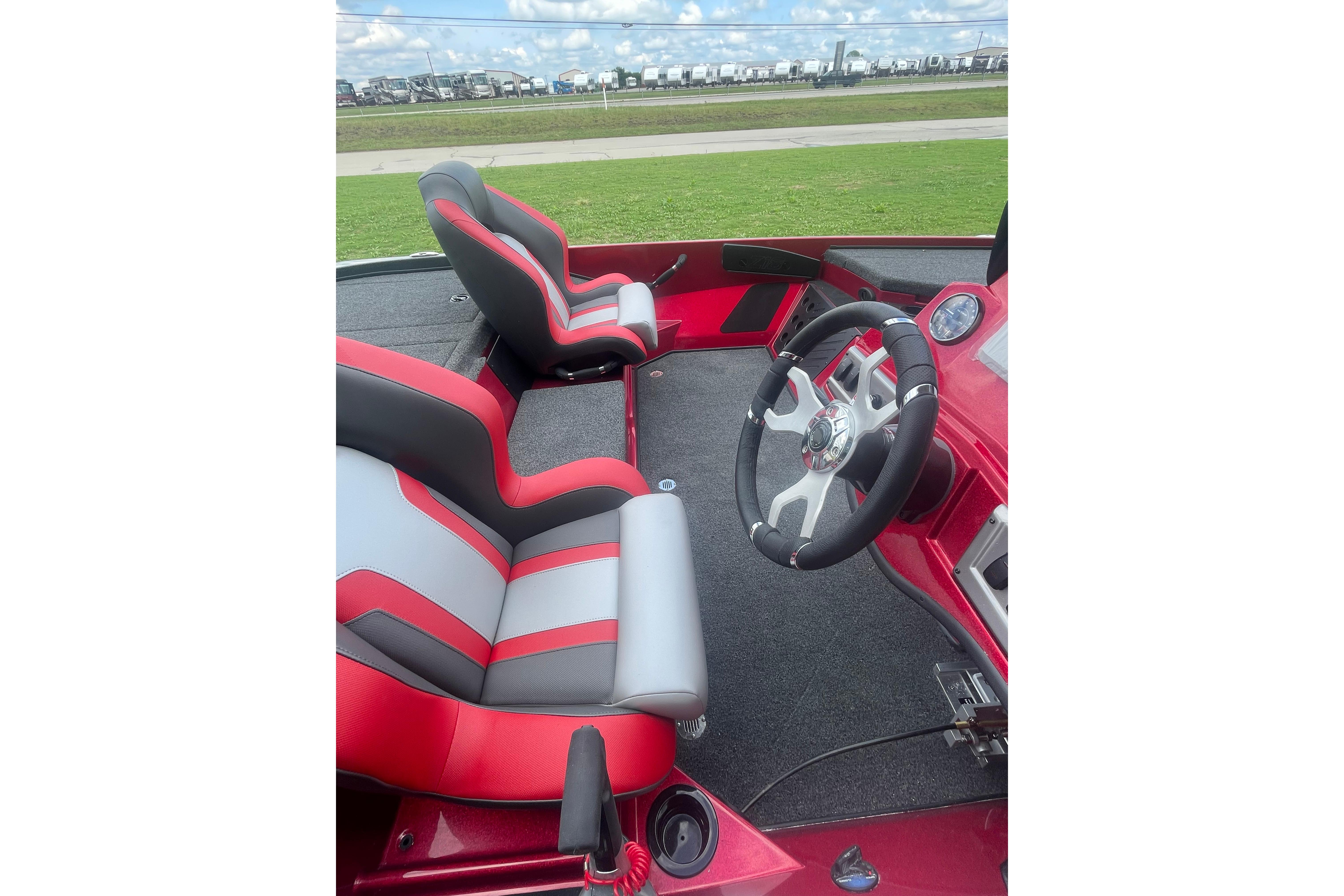 Interior of 2026 Nitro Z18 Pro boat with red and gray seating and steering wheel.