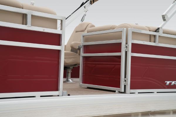 2024 Sun Tracker Party Barge 20 DLX pontoon boat interior with red panels and beige seating.