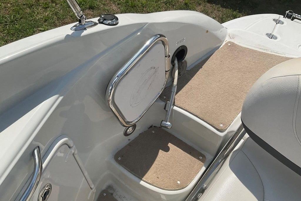 2015 Crownline 236 SC boat interior with beige carpet and chrome details.