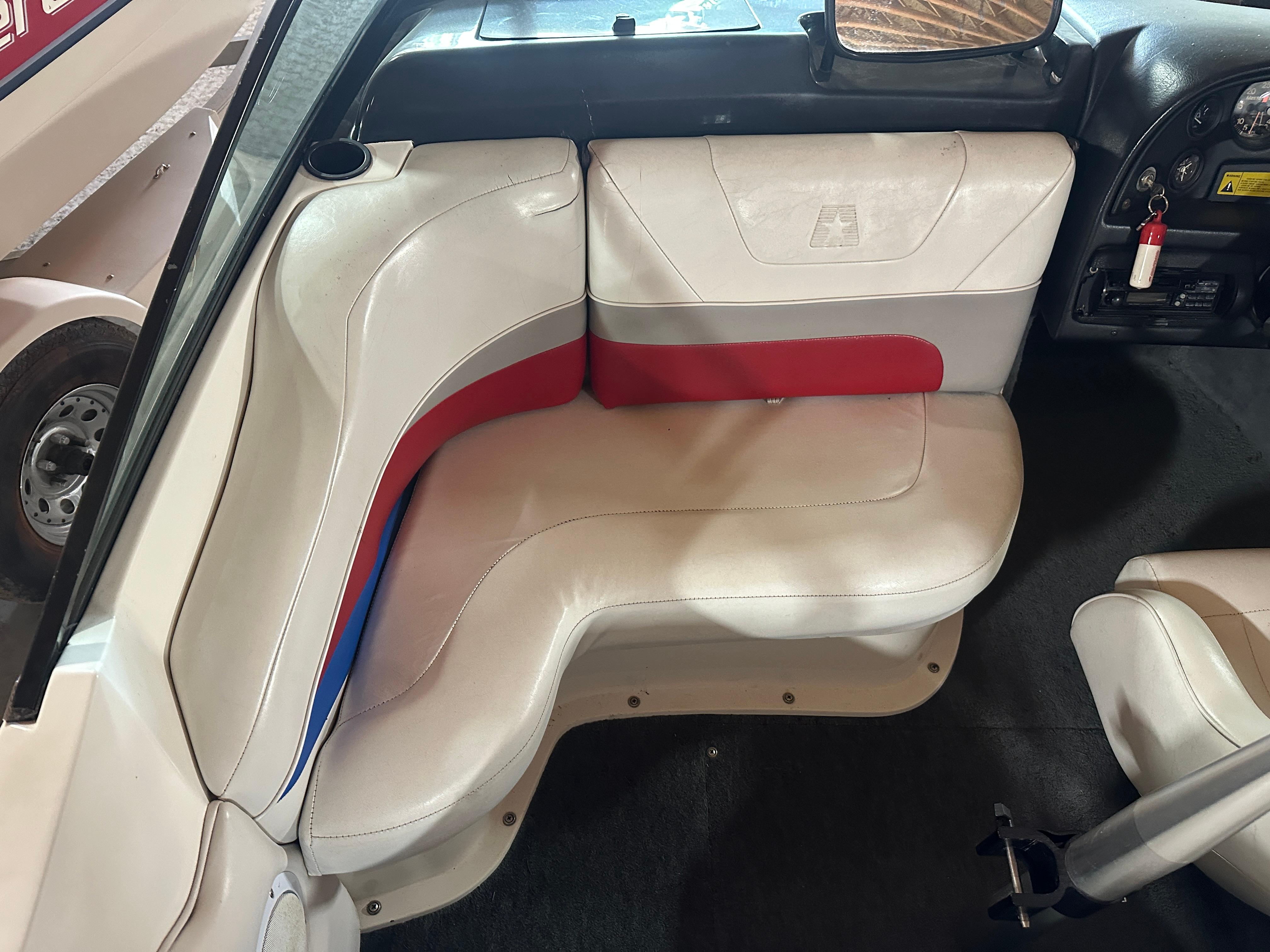 1993 MasterCraft ProStar 190 interior with white and red seating, dashboard, and steering wheel.
