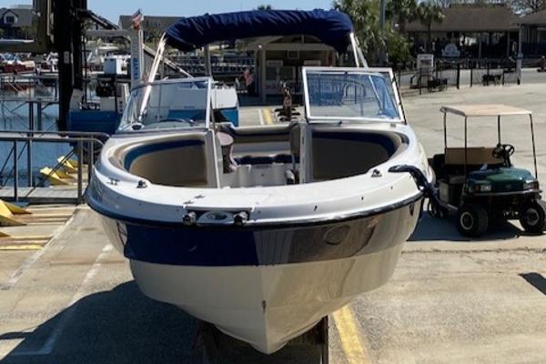 2005 Bayliner 249 SD boat docked at a marina, front view.