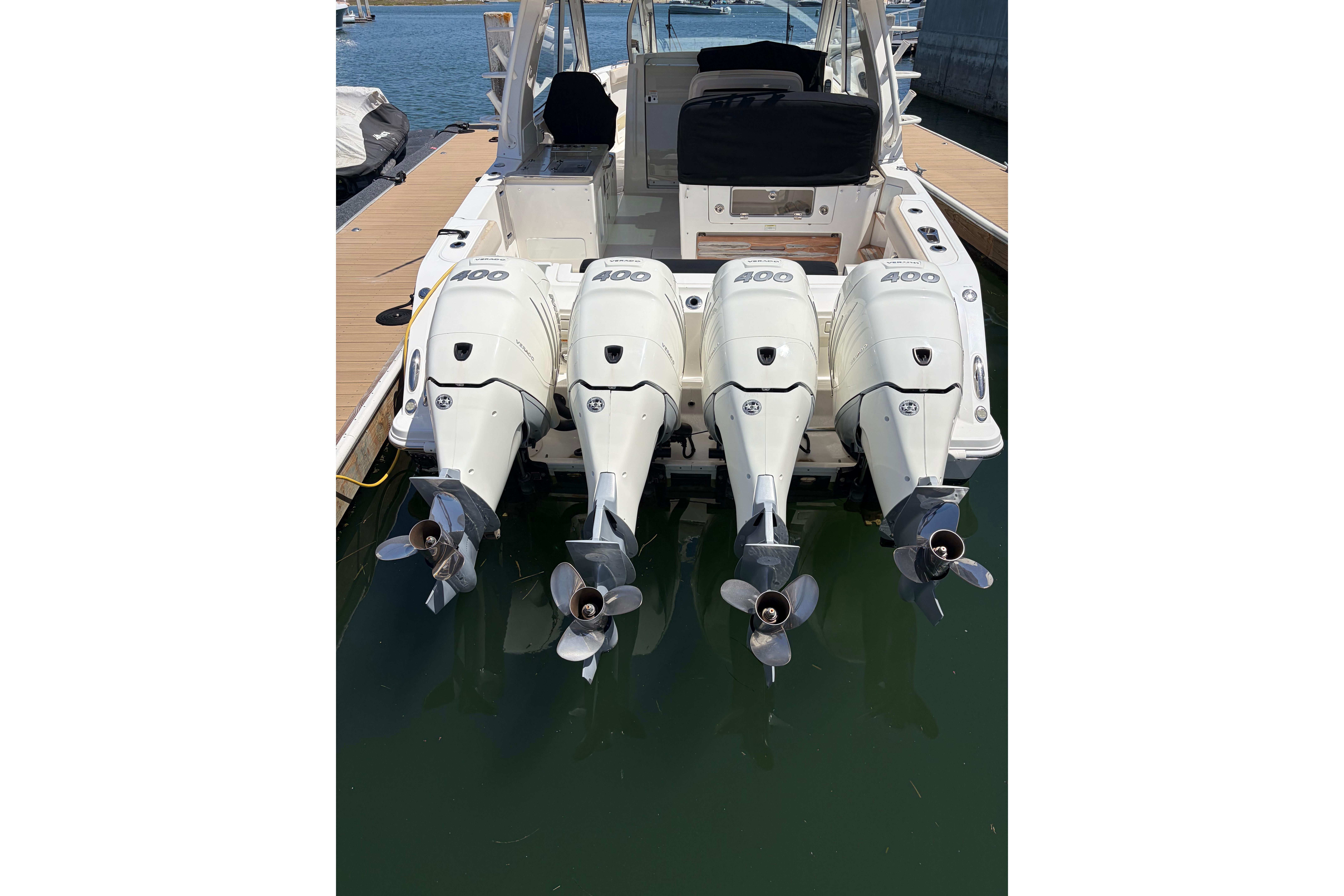 Boston Whaler 380 Realm 2020 with four powerful outboard engines docked at marina.