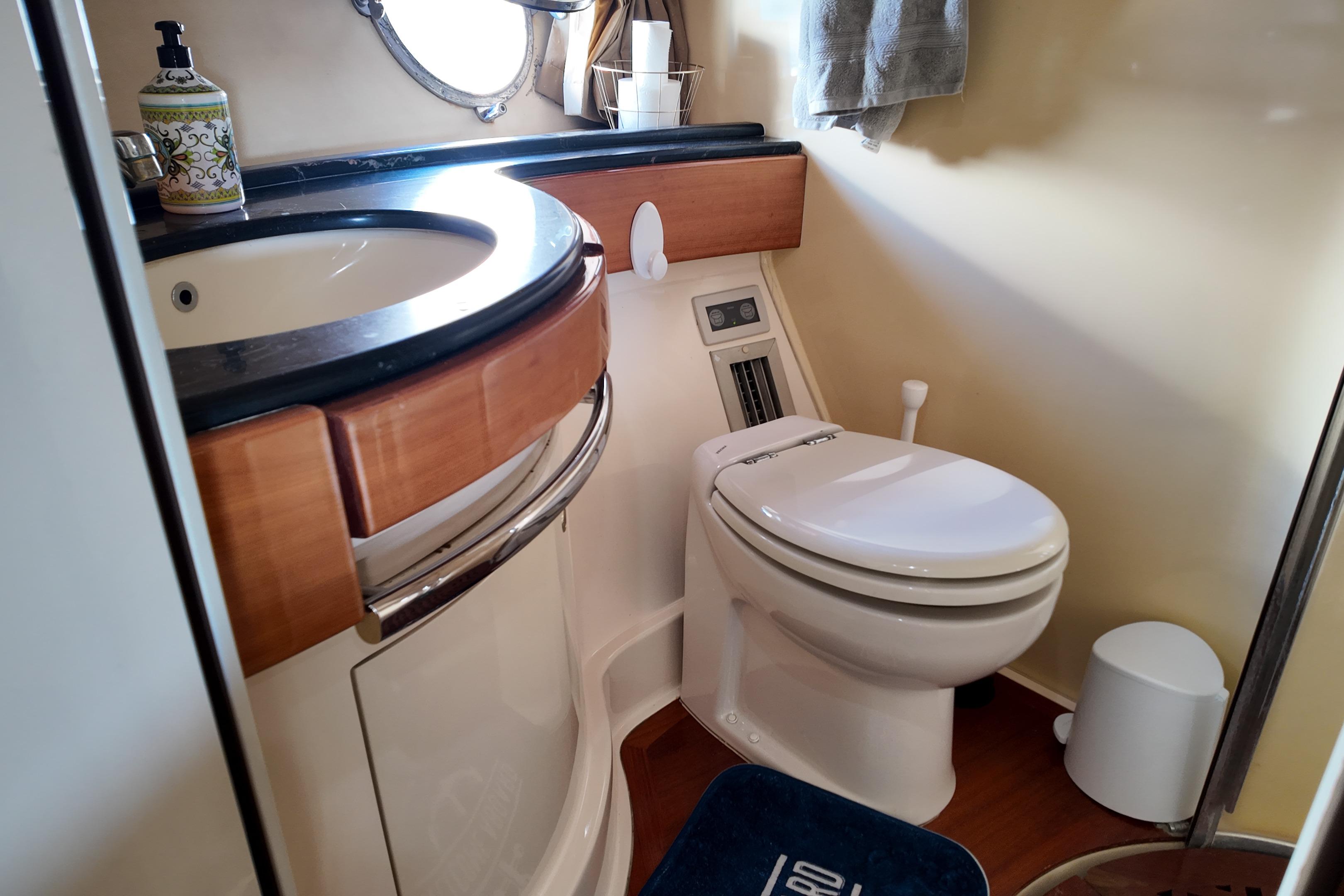 Bathroom interior of a 2006 Azimut 68E yacht, featuring a sink and toilet.