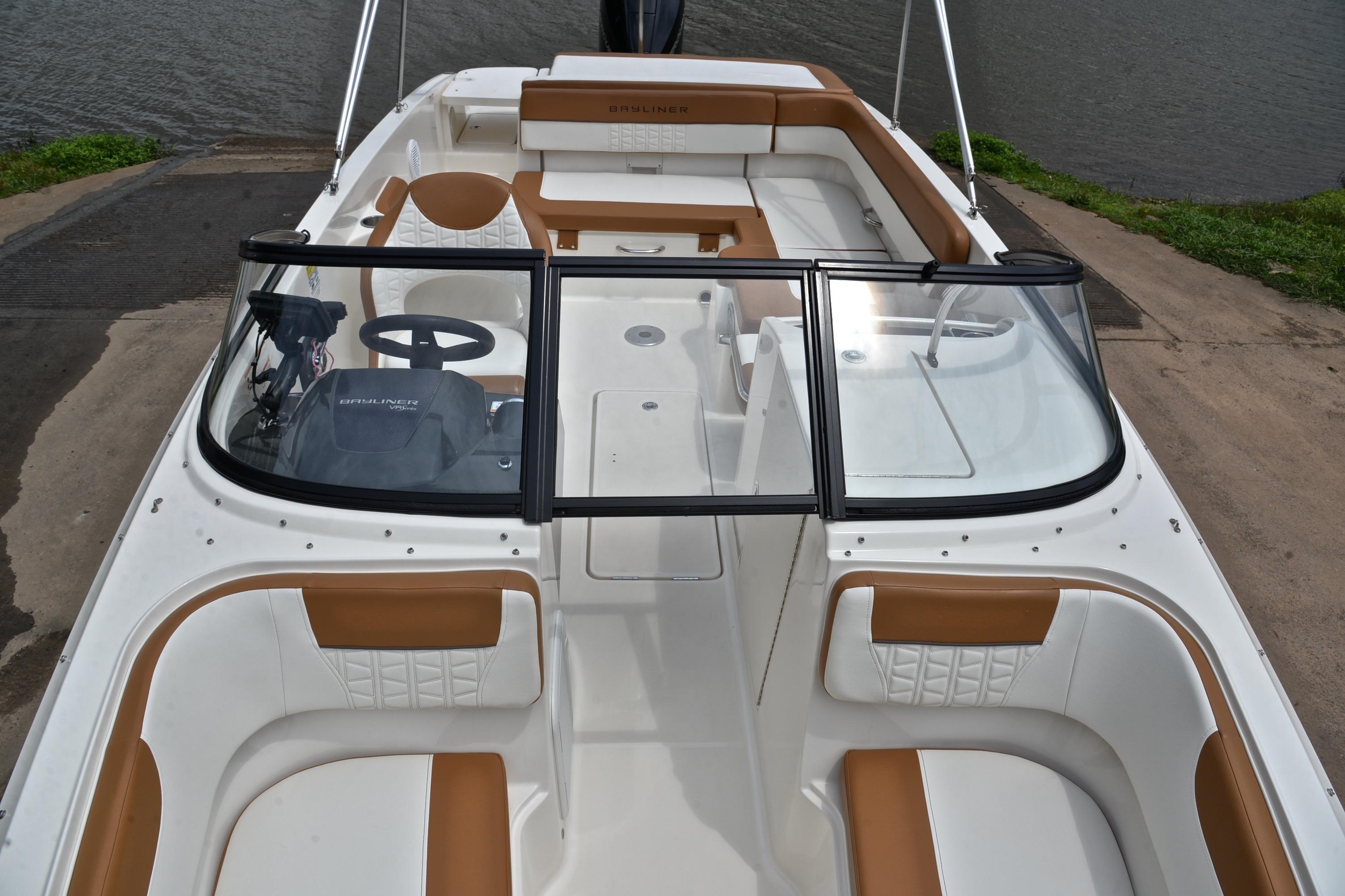 2019 Bayliner VR6 Bowrider OB with spacious seating and sleek design by the water.