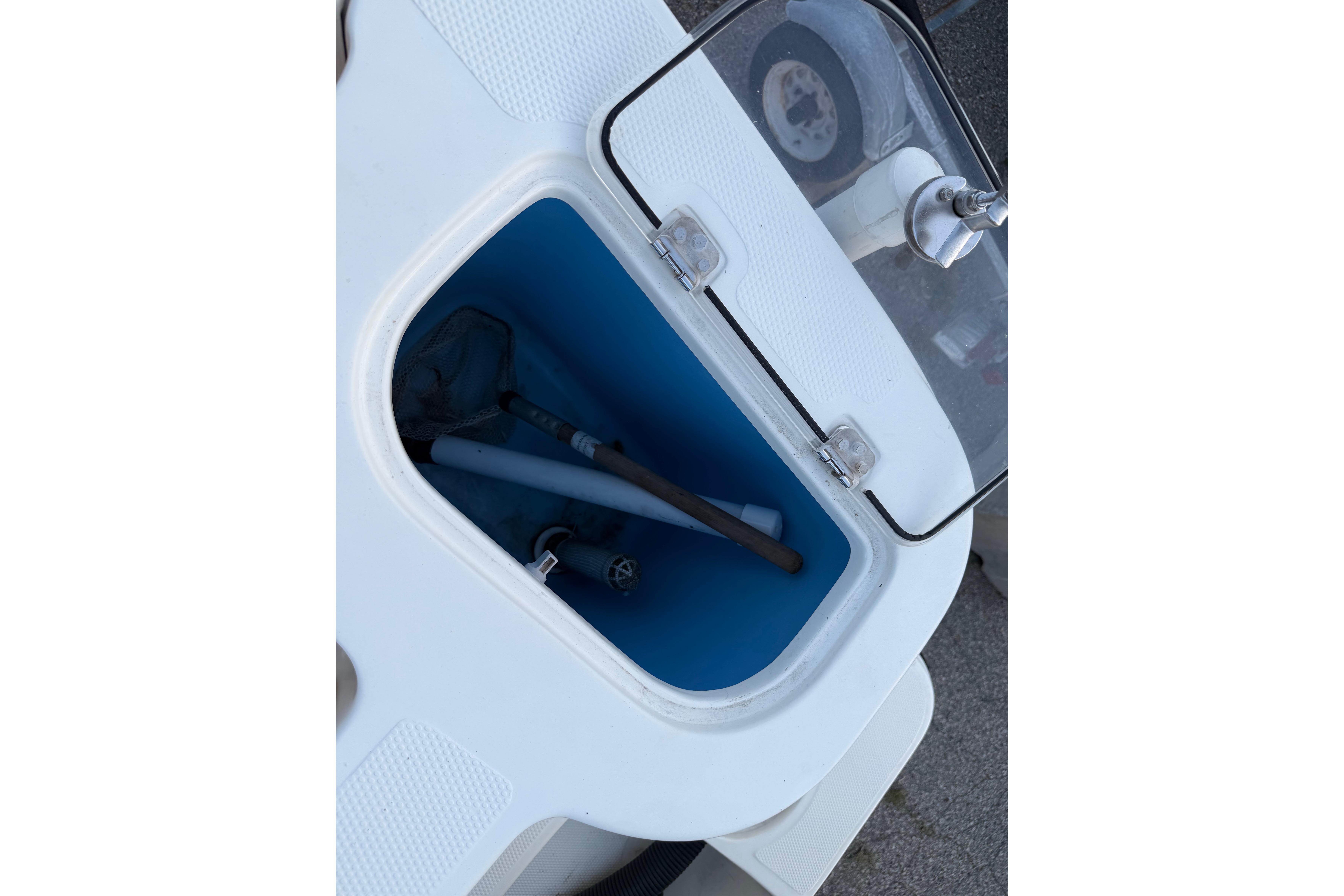 Open storage compartment on a 2007 Mako 234 Center Console boat.