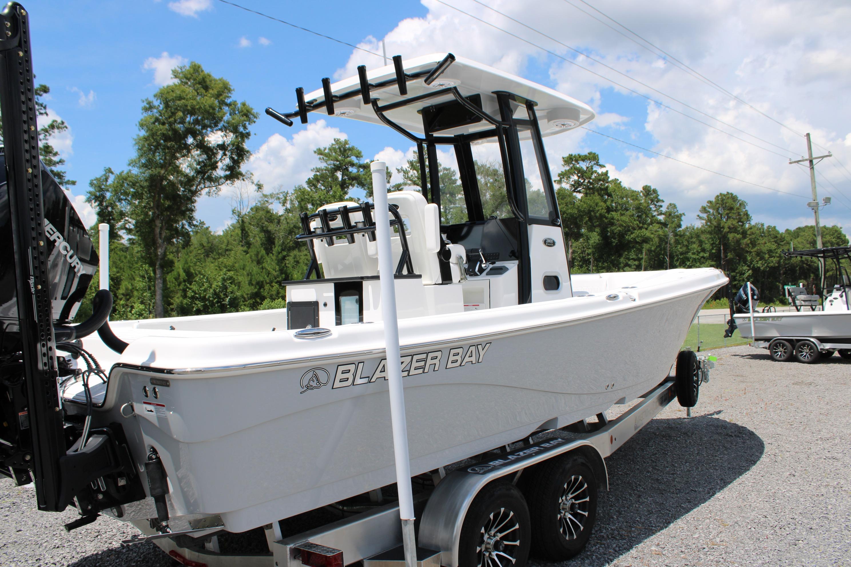2027 Blazer Bay Makaira 2800 boat on trailer, parked outdoors under blue sky.