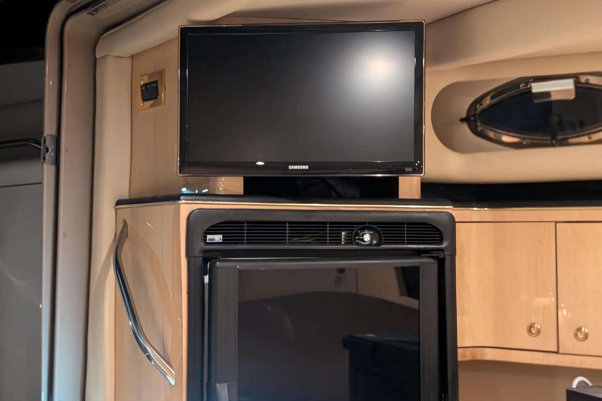 Interior of 2000 Sea Ray 380 Sundancer with TV and refrigerator.