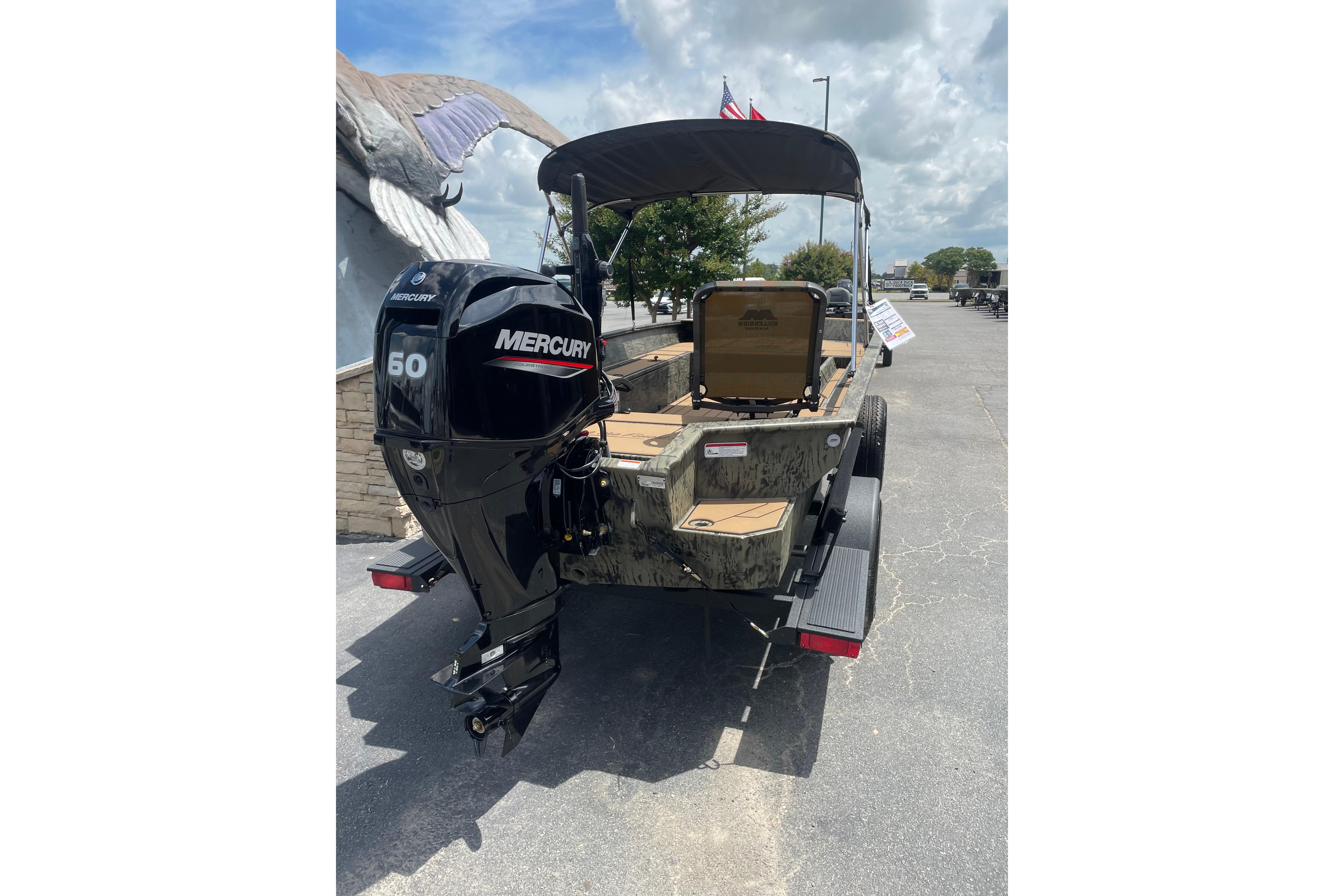 2026 Tracker Grizzly 1756 T Marsh boat with Mercury 60 engine, parked outdoors.
