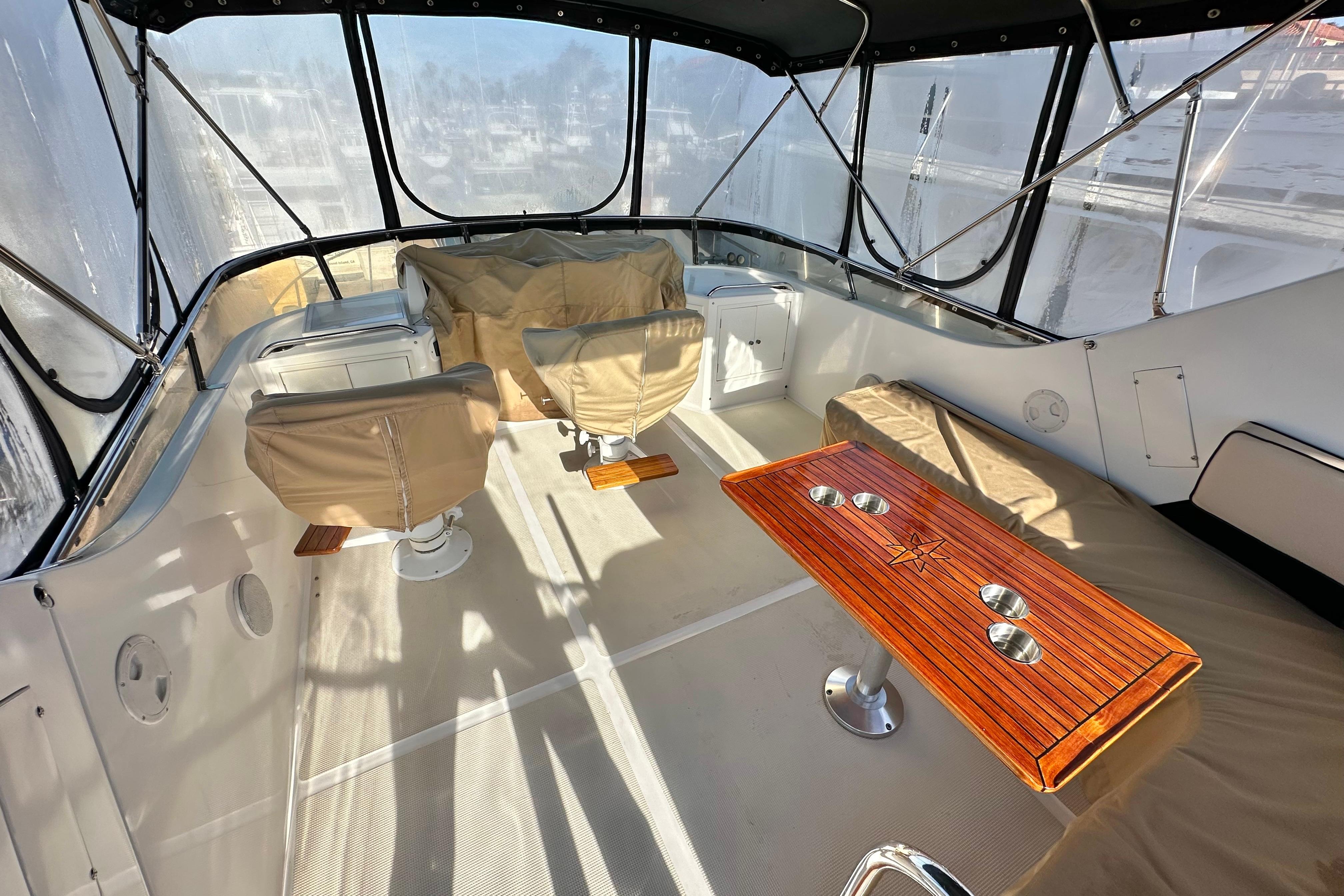 Interior of 2003 Ocean Alexander 42 Sport Sedan with seating and wooden table.
