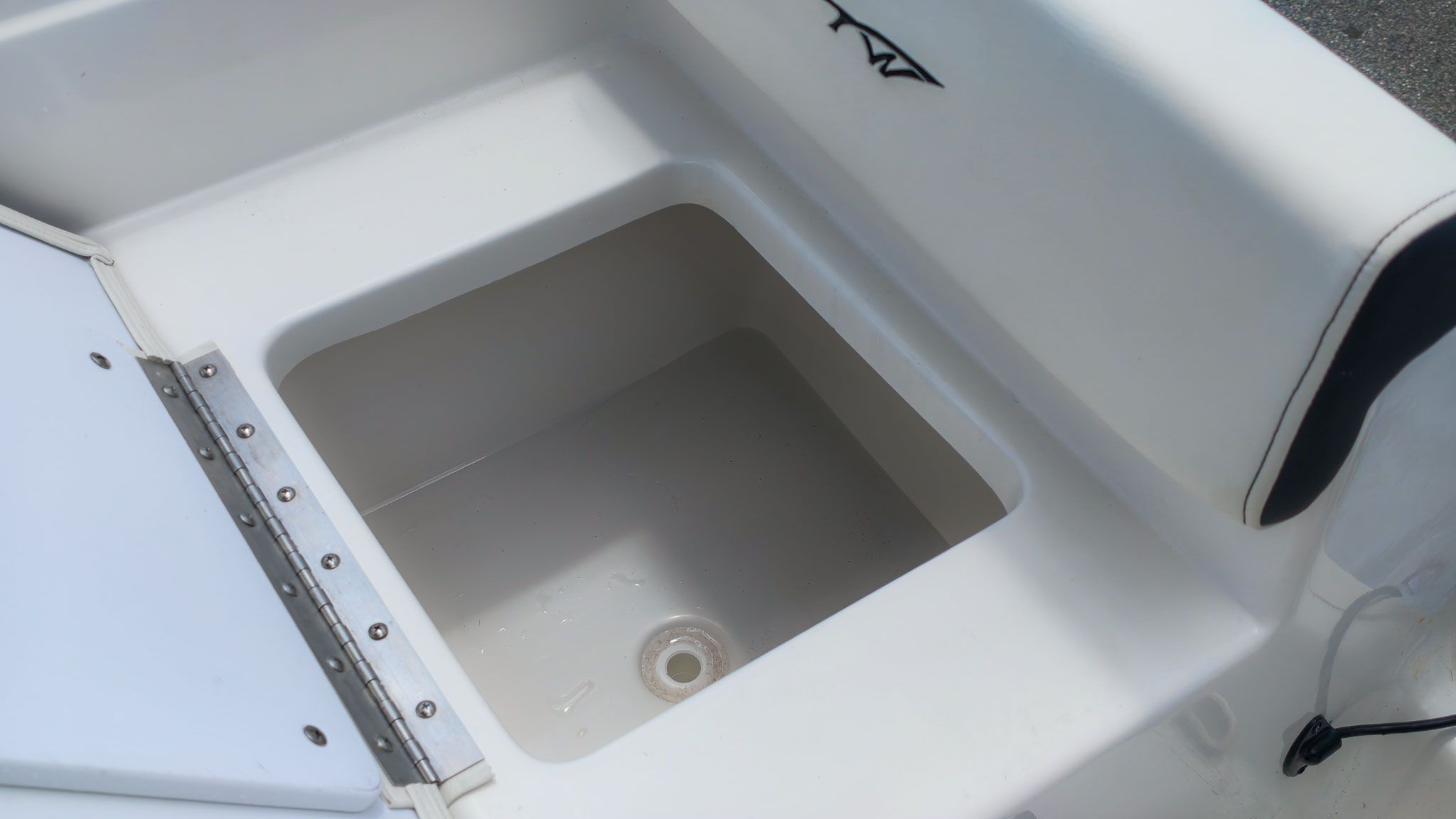 An open storage compartment on a 2027 Tidewater 198 CC Adventure boat.