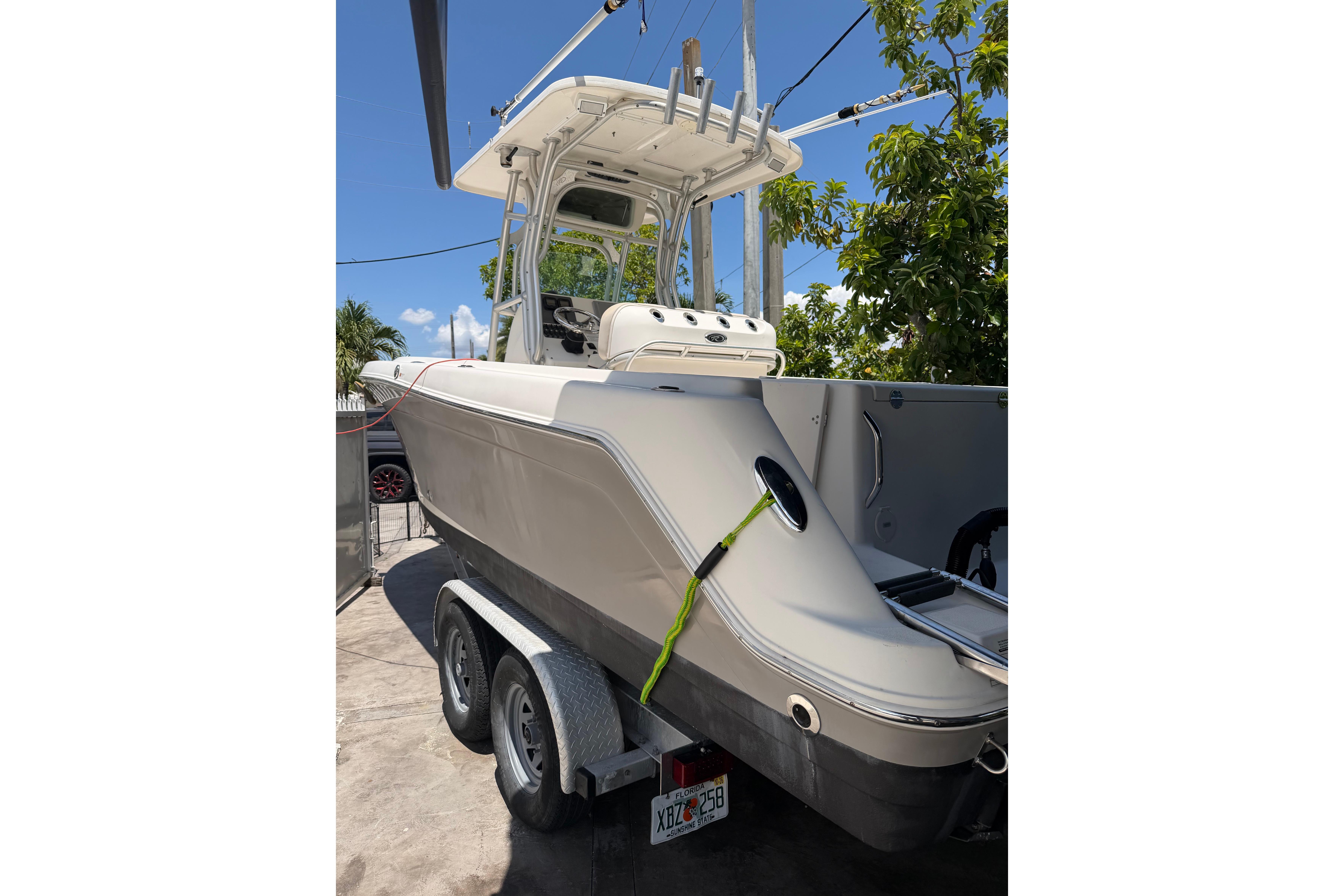 2007 Robalo R260 Center Console boat on trailer, parked outdoors.