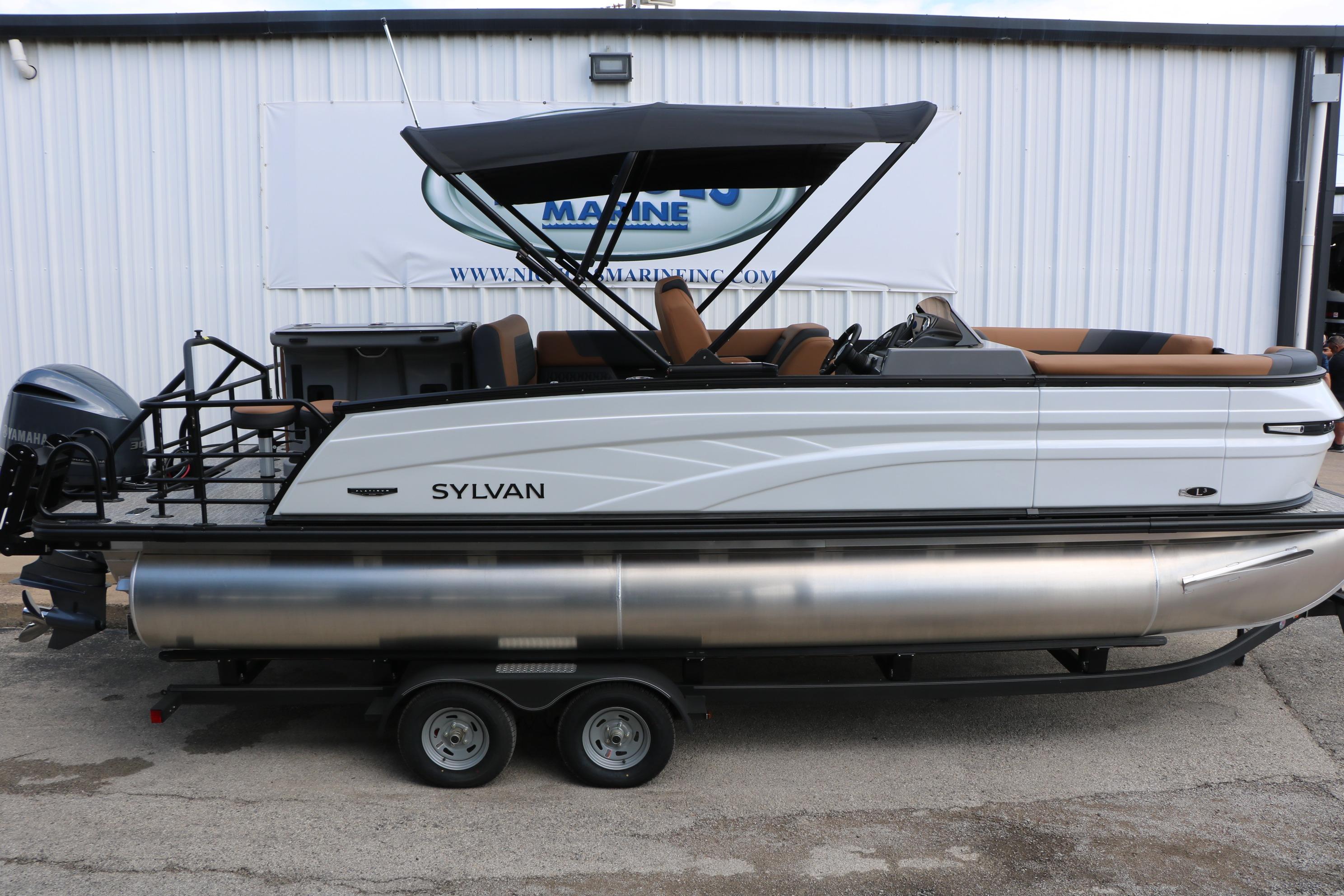2026 Sylvan L3 DLZ Bar Platinum Edition Tri-Toon boat on trailer, side view.