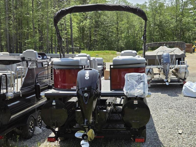 2025 Regency 230 DL3 pontoon boat with outboard motor, parked on gravel lot.