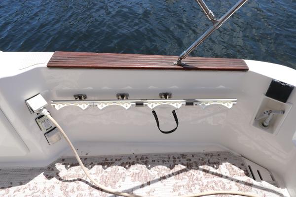 1992 Sea Ray 350 Express Bridge boat deck with rod holders and water view.
