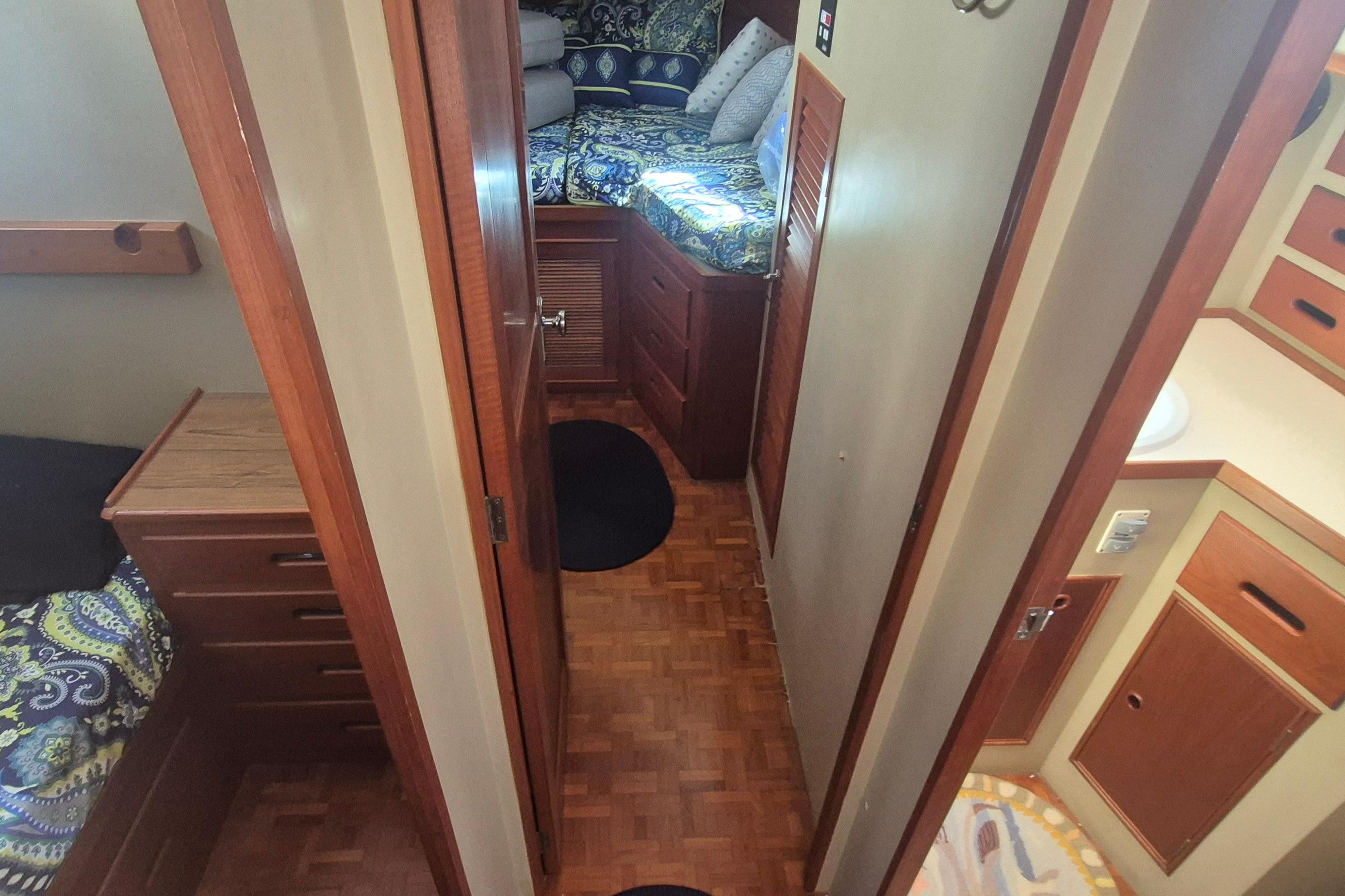 Interior of 1983 Grand Banks 42 Motoryacht with wood paneling and patterned bedding.