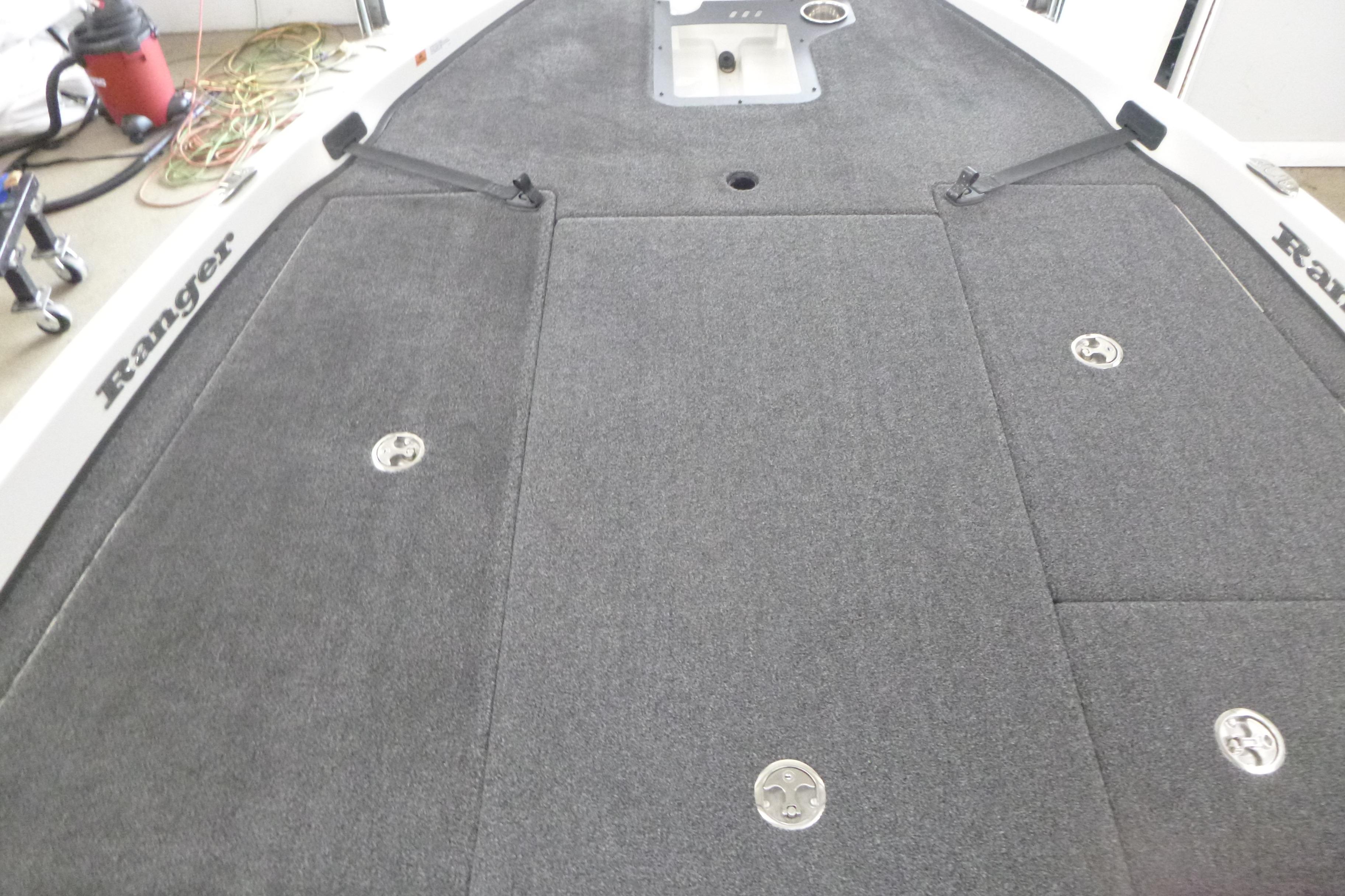 2025 Ranger Z185 boat deck with gray carpet and storage compartments.