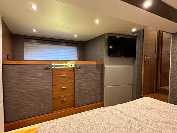 Interior cabin of 2019 Tiara Yachts C53 with modern furnishings and TV.