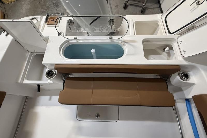 2026 Sea Pro 242 Center Console boat interior with seating and storage compartments.