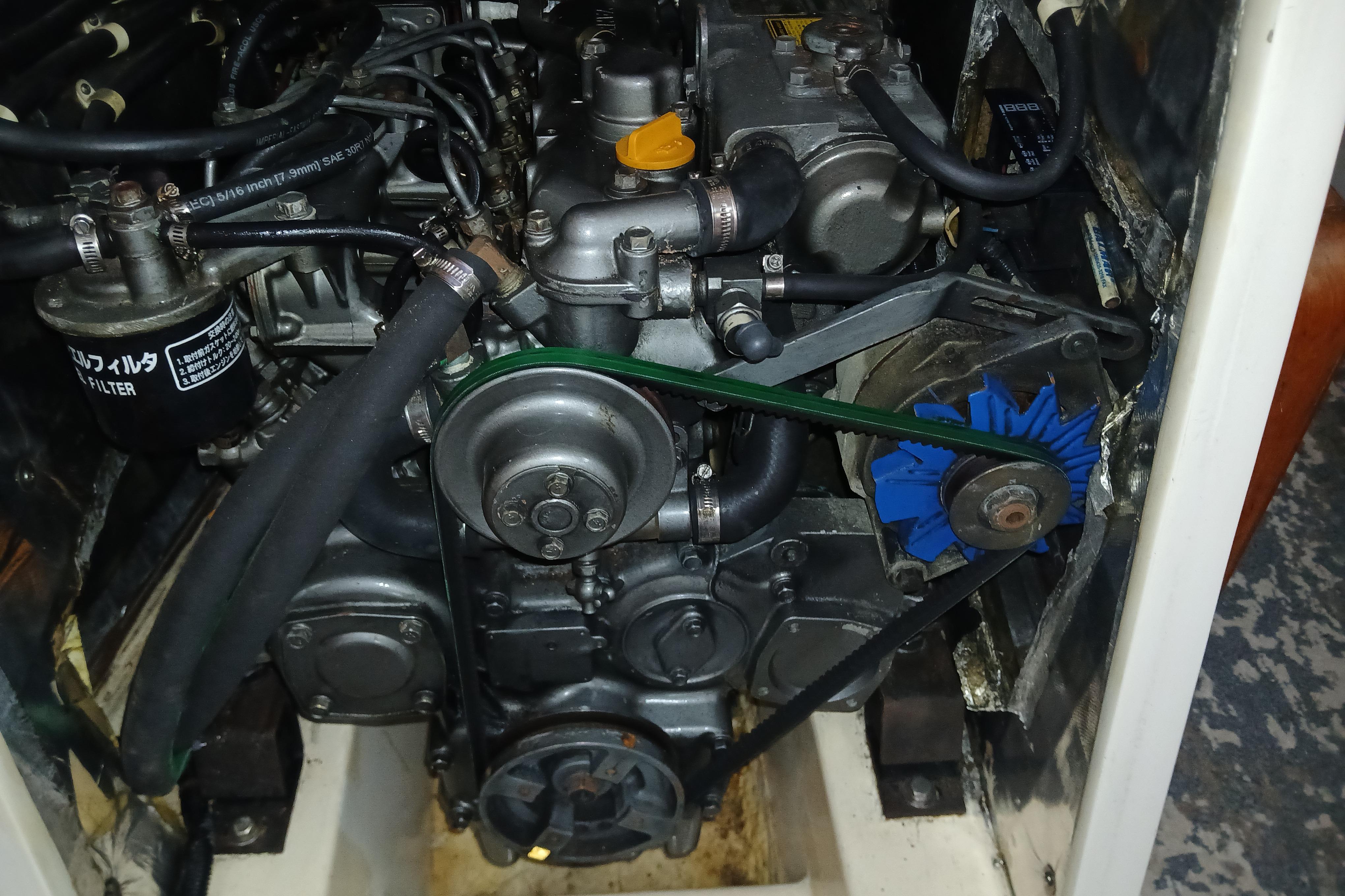 Engine compartment of a 1995 Catalina 42 MkII sailboat, showcasing mechanical components and belts.