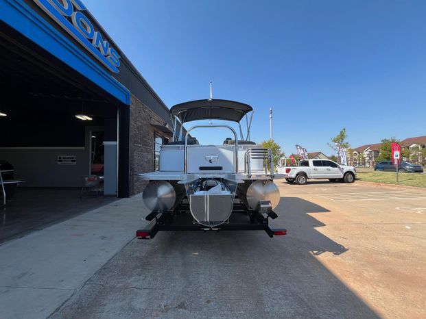 2025 Tahoe LTZ QL pontoon boat parked in front of a building.