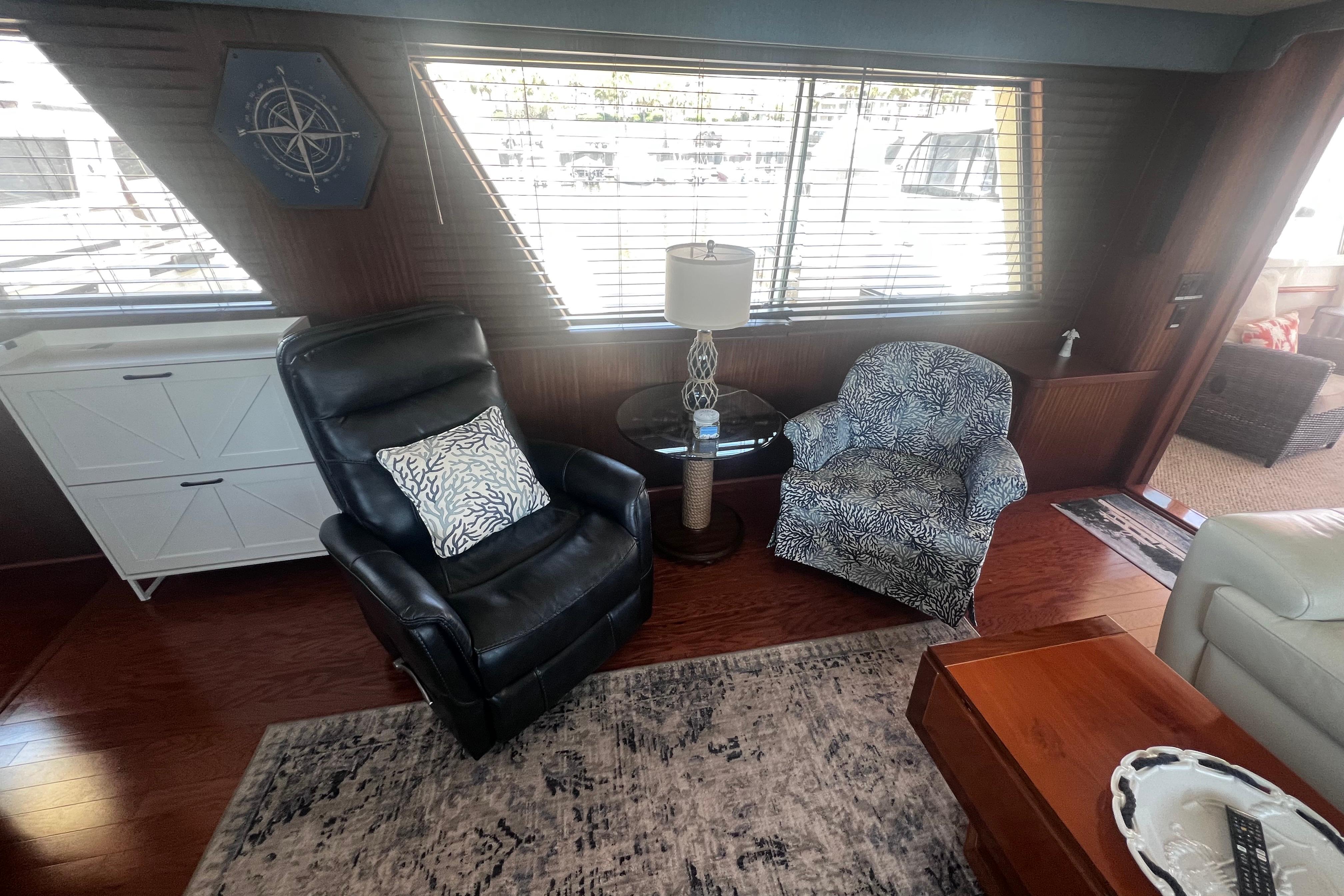 Interior of 1987 Hatteras 70 Cockpit Motor Yacht with cozy seating and nautical decor.