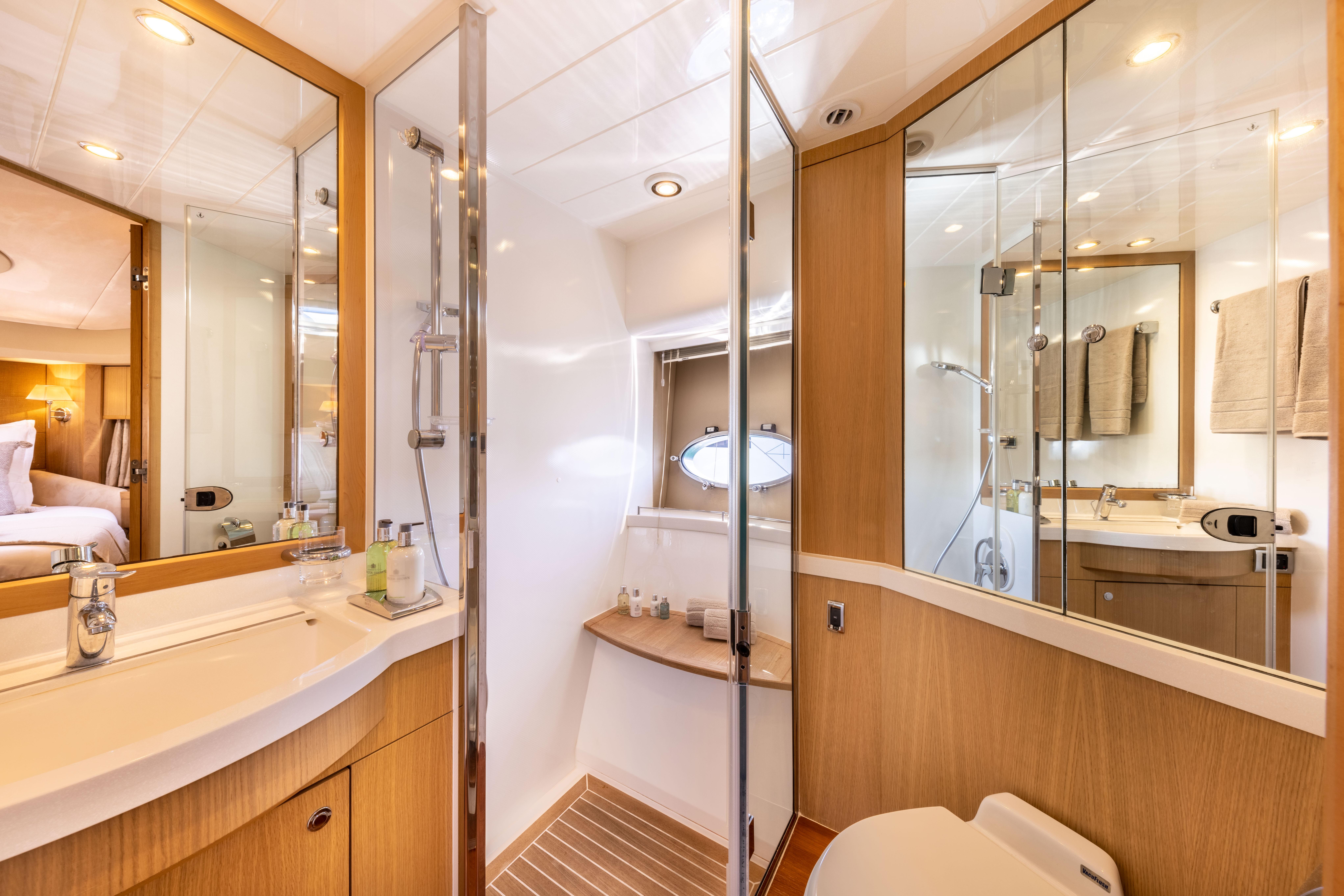 Luxurious bathroom interior of 2008 Princess V70 yacht with modern fixtures and wooden accents.