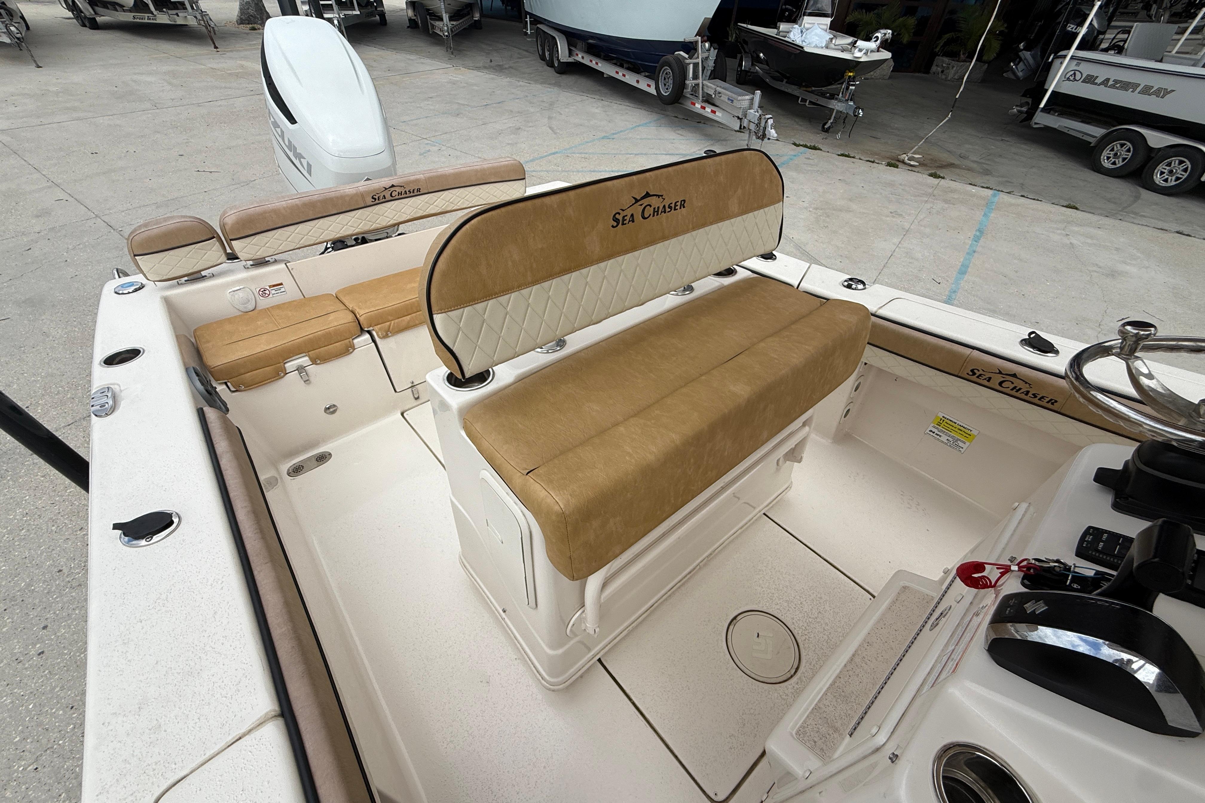 2023 SeaChaser 24 HFC boat interior with tan seating and steering console.