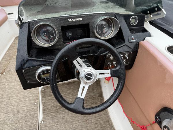 Steering wheel and dashboard of a 2017 Glastron 205 boat.
