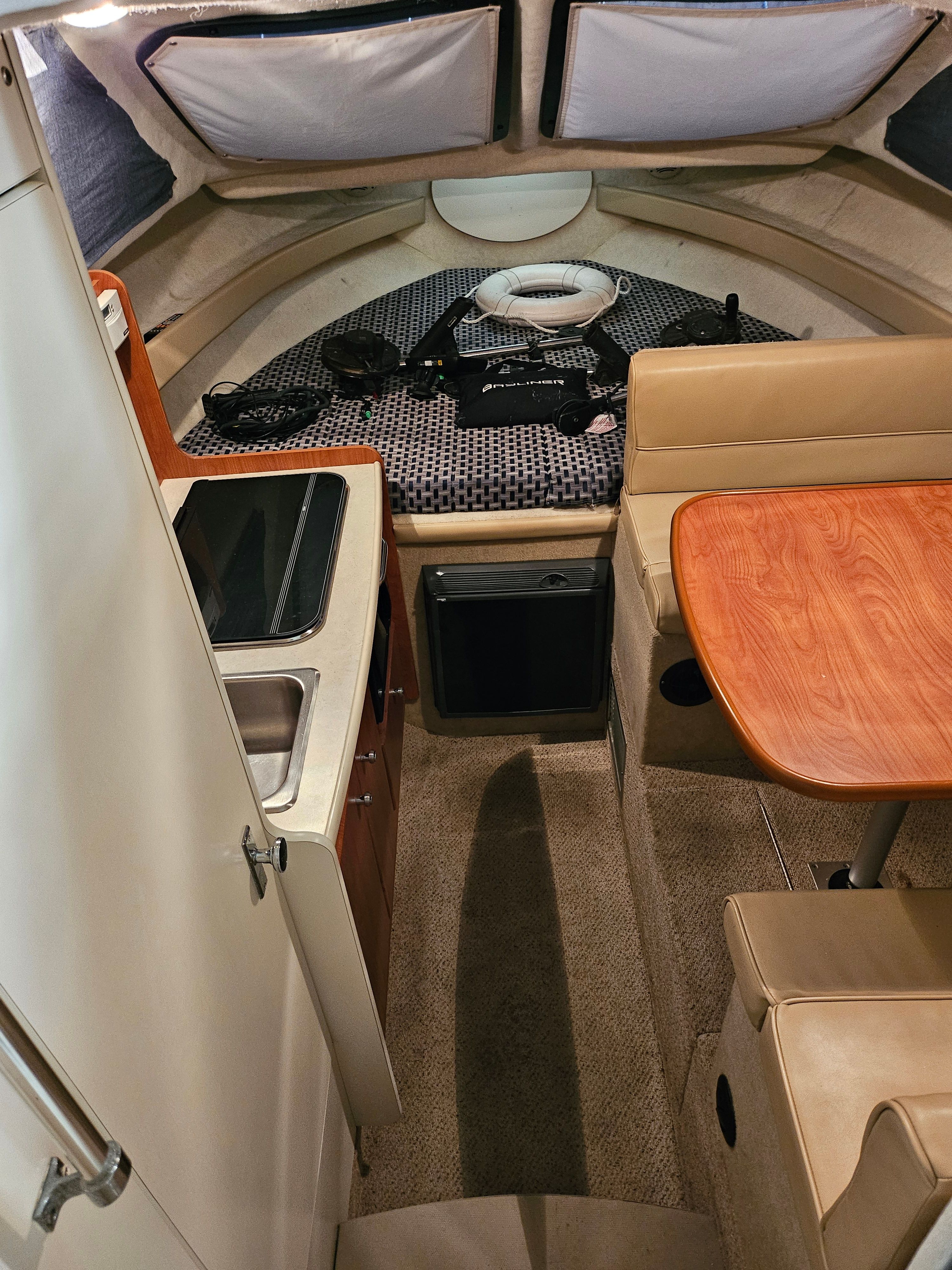 Interior of a 2005 Bayliner 242 Ceara with kitchenette and seating area.