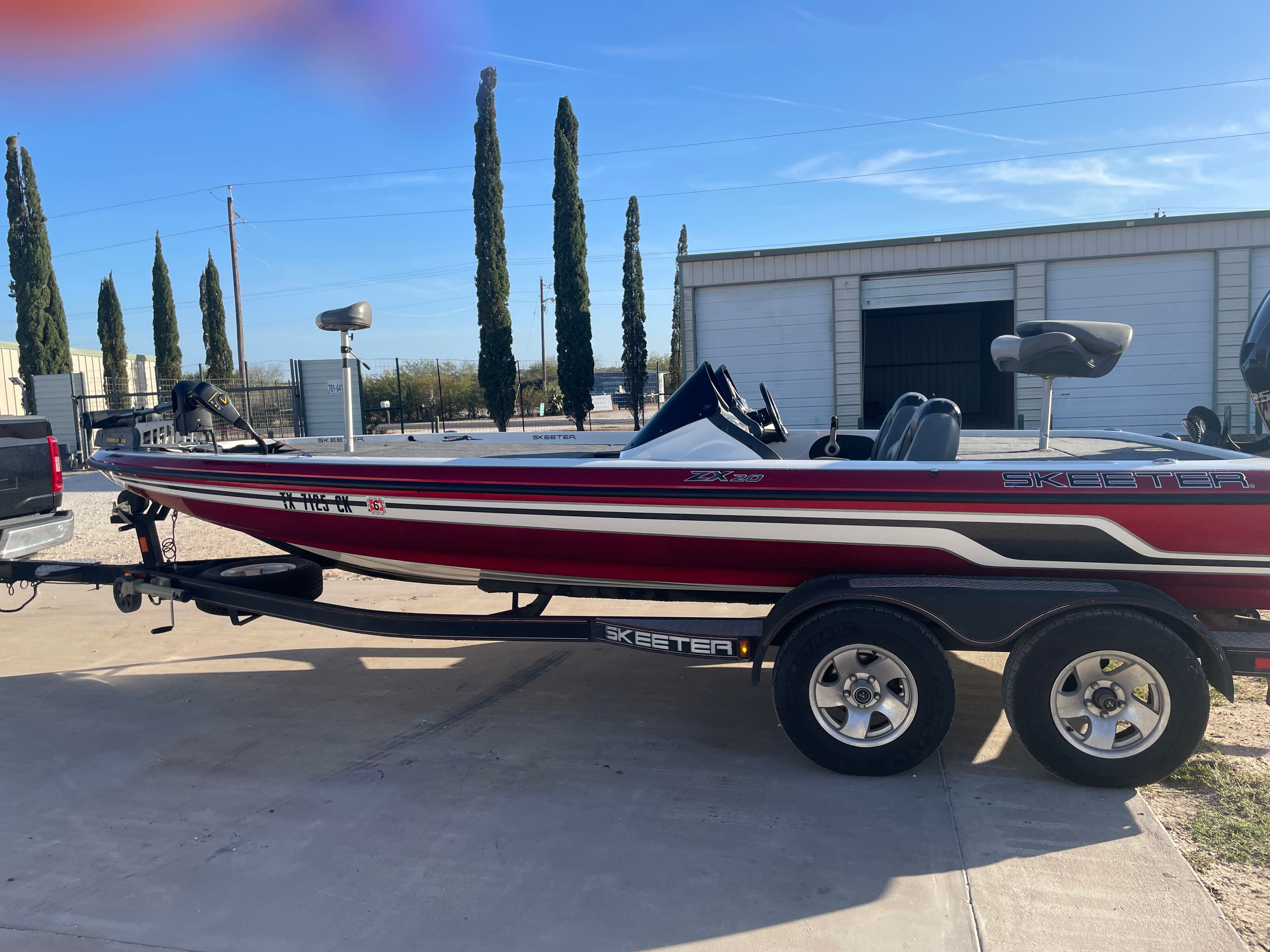 2012 Skeeter ZX20 boat on trailer in front of storage building.