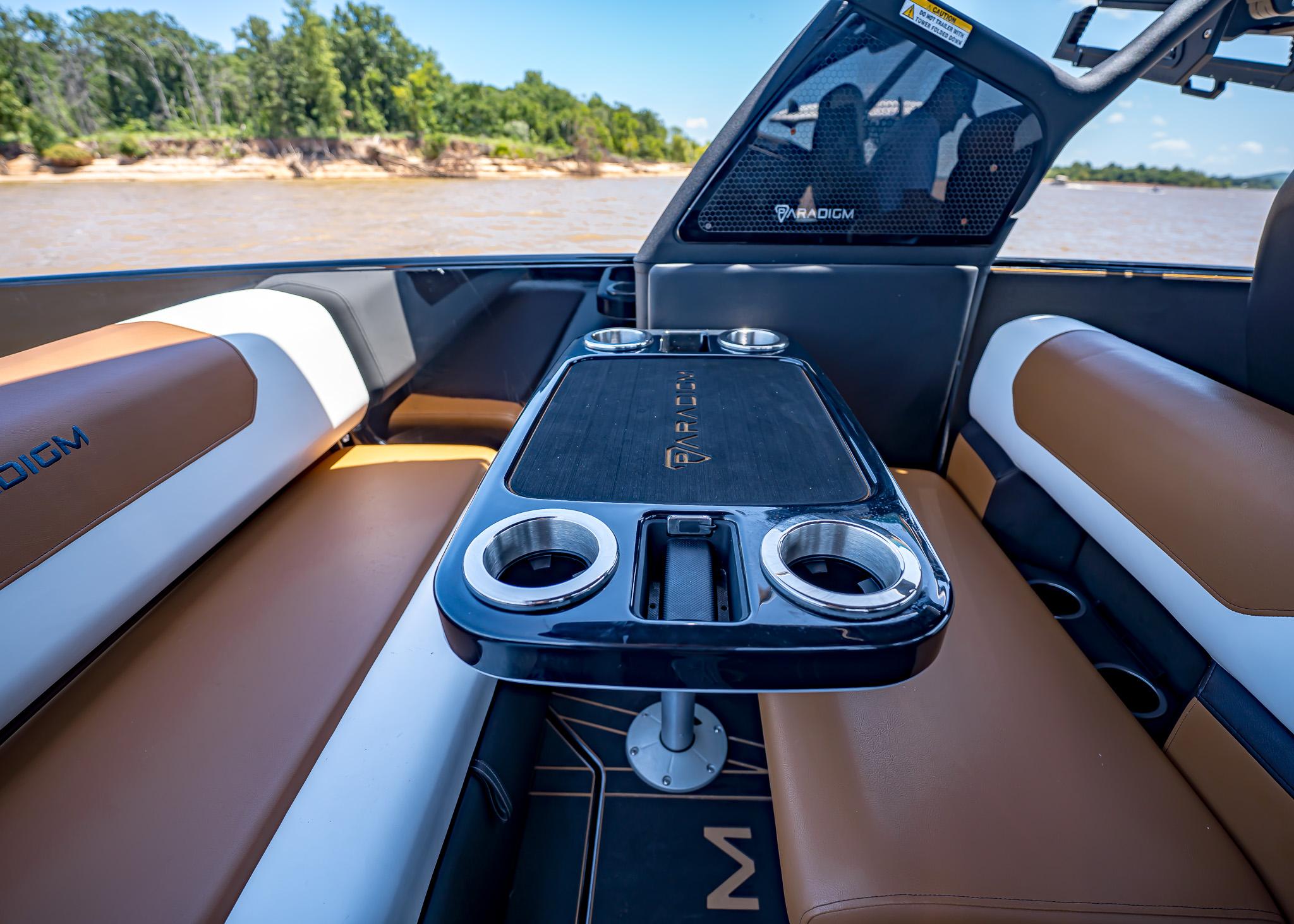 Luxurious interior of 2025 Paradigm 236 boat with sleek seating and modern table design.
