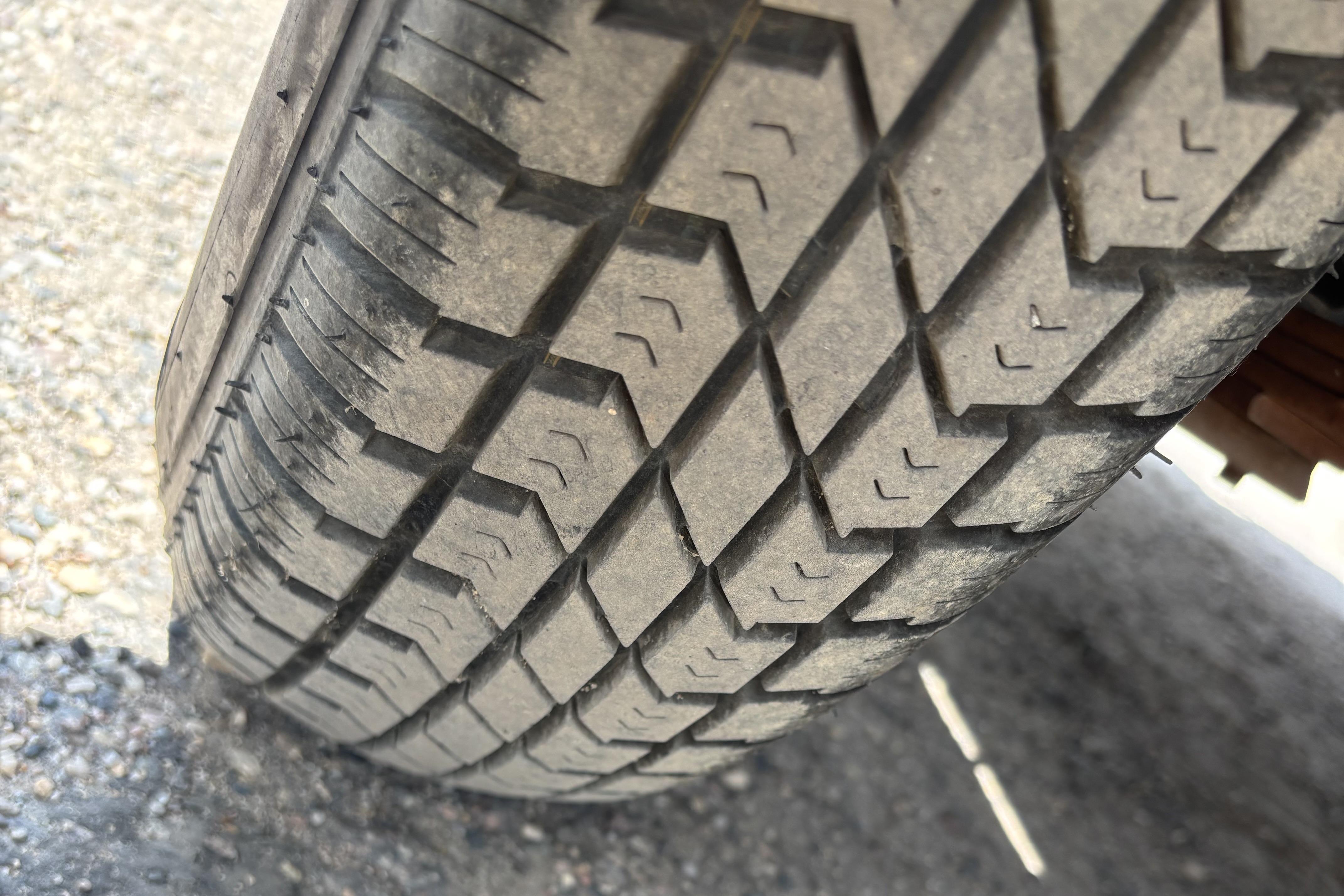 Close-up of a tire tread on a 1997 Northwood 24' Pontoon trailer.