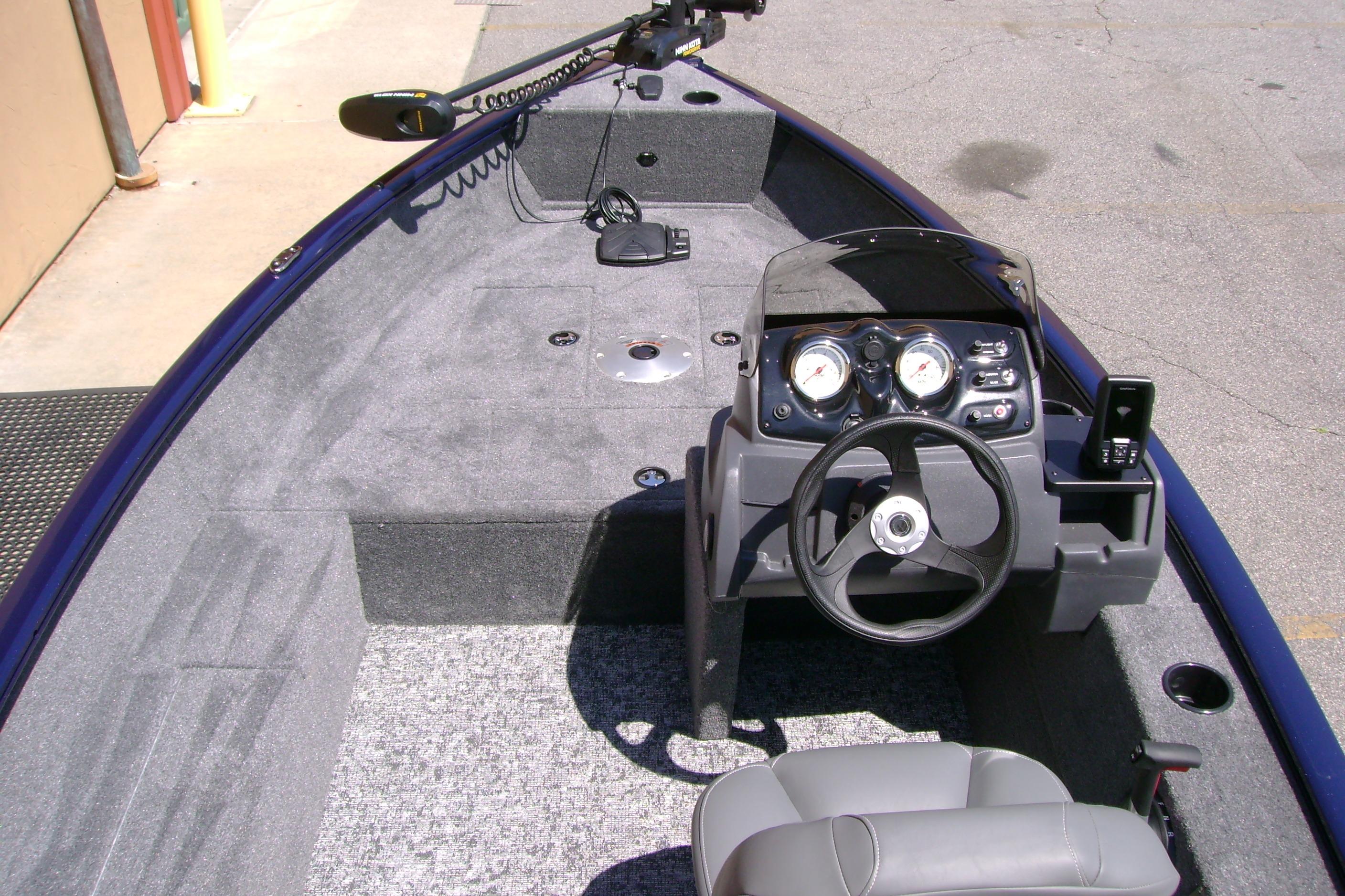 Interior view of 2026 Tracker Super Guide V-16 SC boat with steering console and seating.