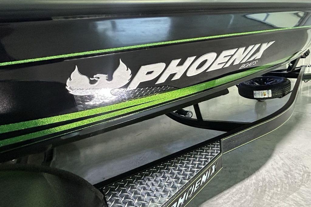 2026 Phoenix 819 ZXL boat with green accents and logo on trailer.