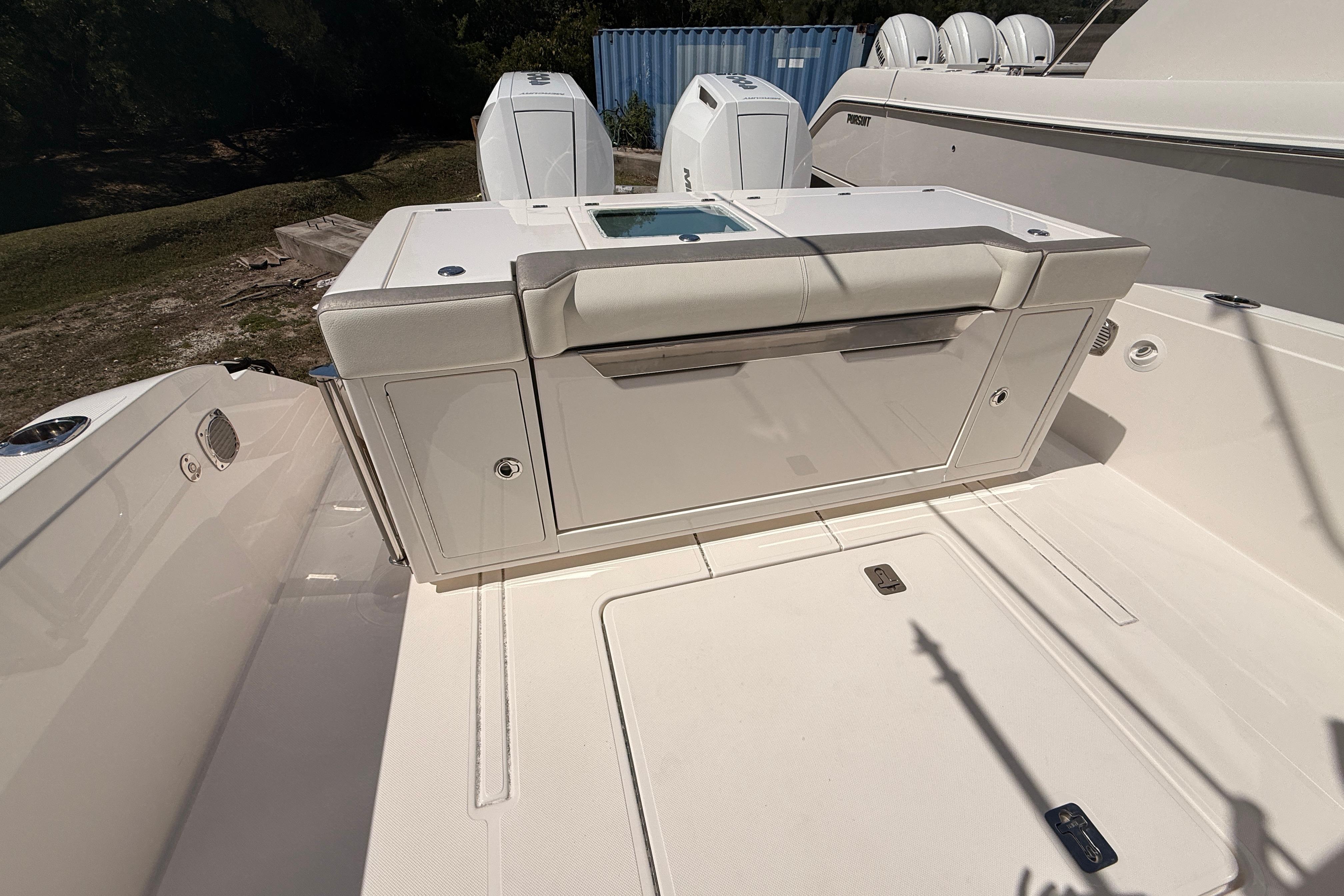 2024 Tiara Yachts 34 LS boat deck with storage compartments and seating.