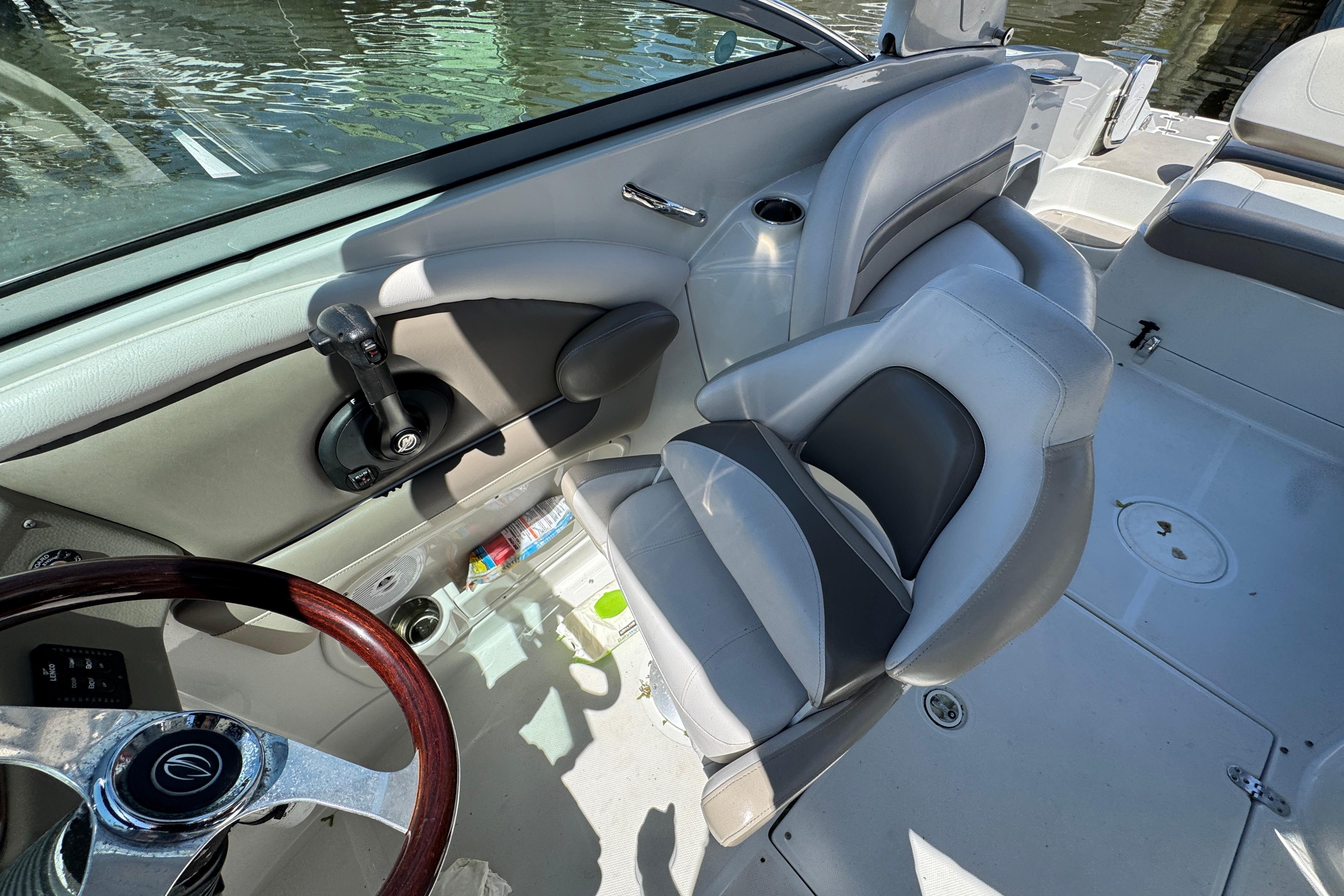 Interior of 2013 Crownline Eclipse E6 XS boat with steering wheel and seating.