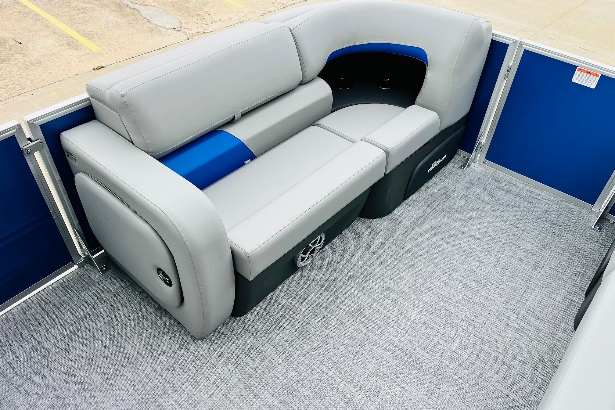 2026 Sun Tracker Party Barge 22 RF DLX interior with gray seating and blue accents.