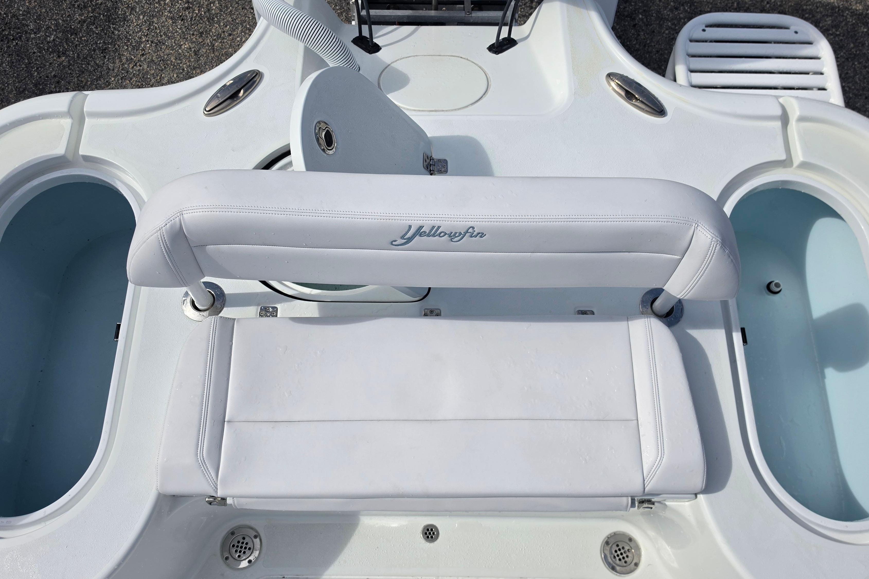 2026 Yellowfin 24 Bay CE boat interior with white seating and storage compartments.