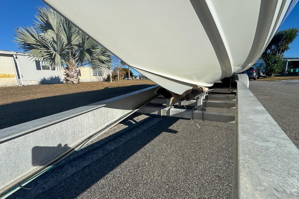 1989 Formula 292 SR-1 boat on trailer, parked outdoors near palm trees.
