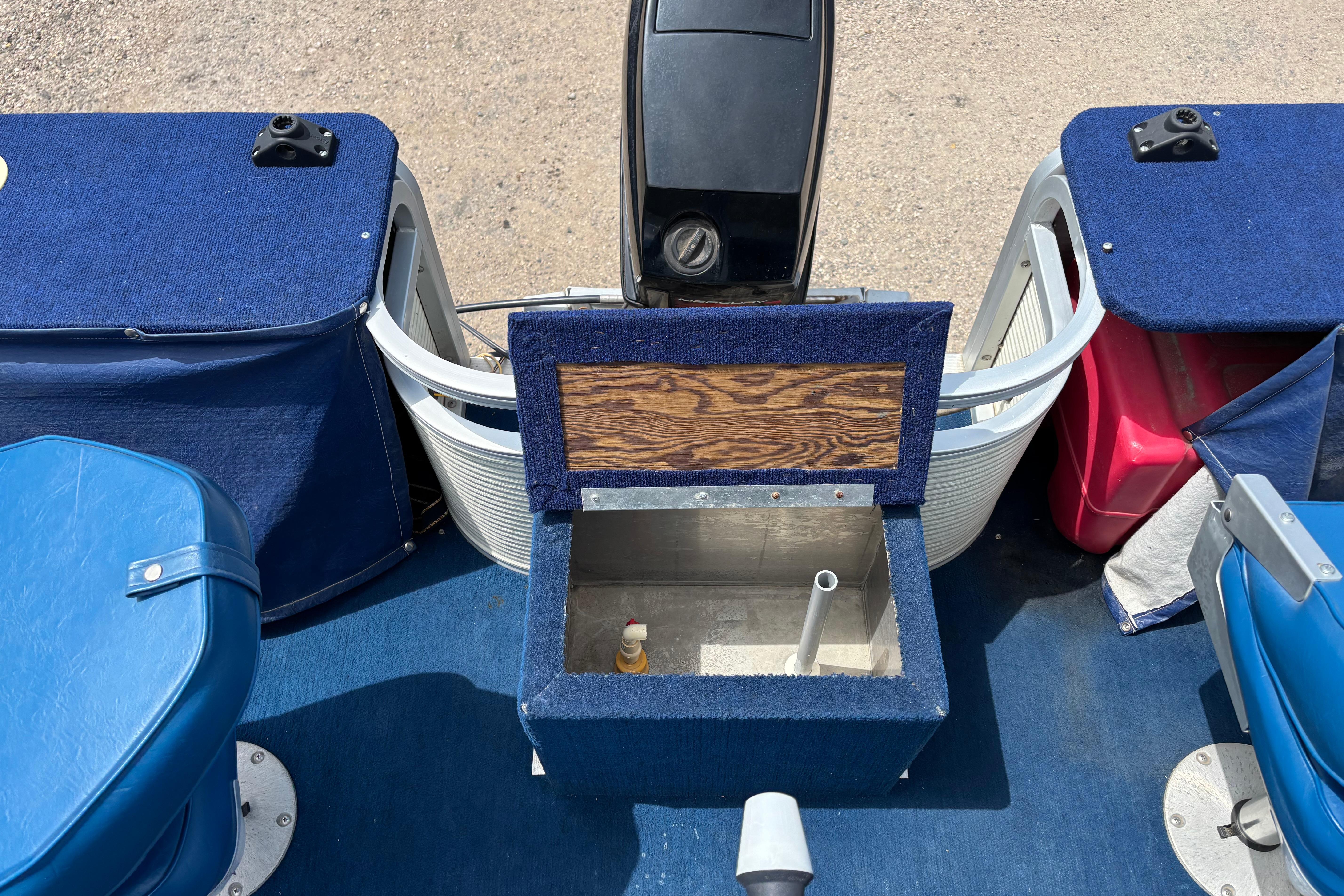 1997 Northwood 24' Pontoon boat interior with blue seating and storage compartments.