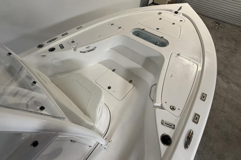 2026 Sea Pro 250 Bay boat interior with storage compartments and seating.
