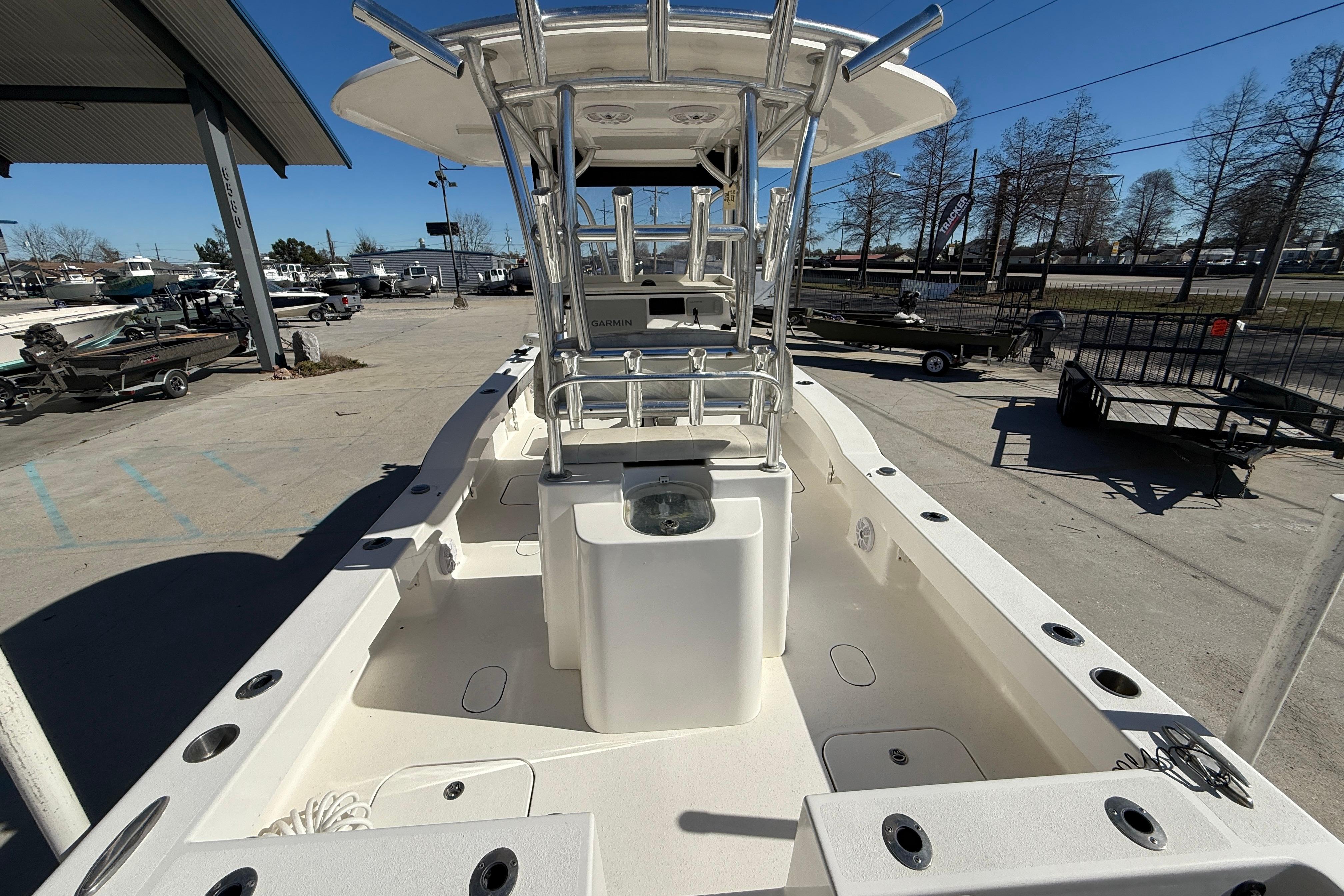 2020 Tideline 235 Hybrid boat with center console and rod holders in a marina setting.