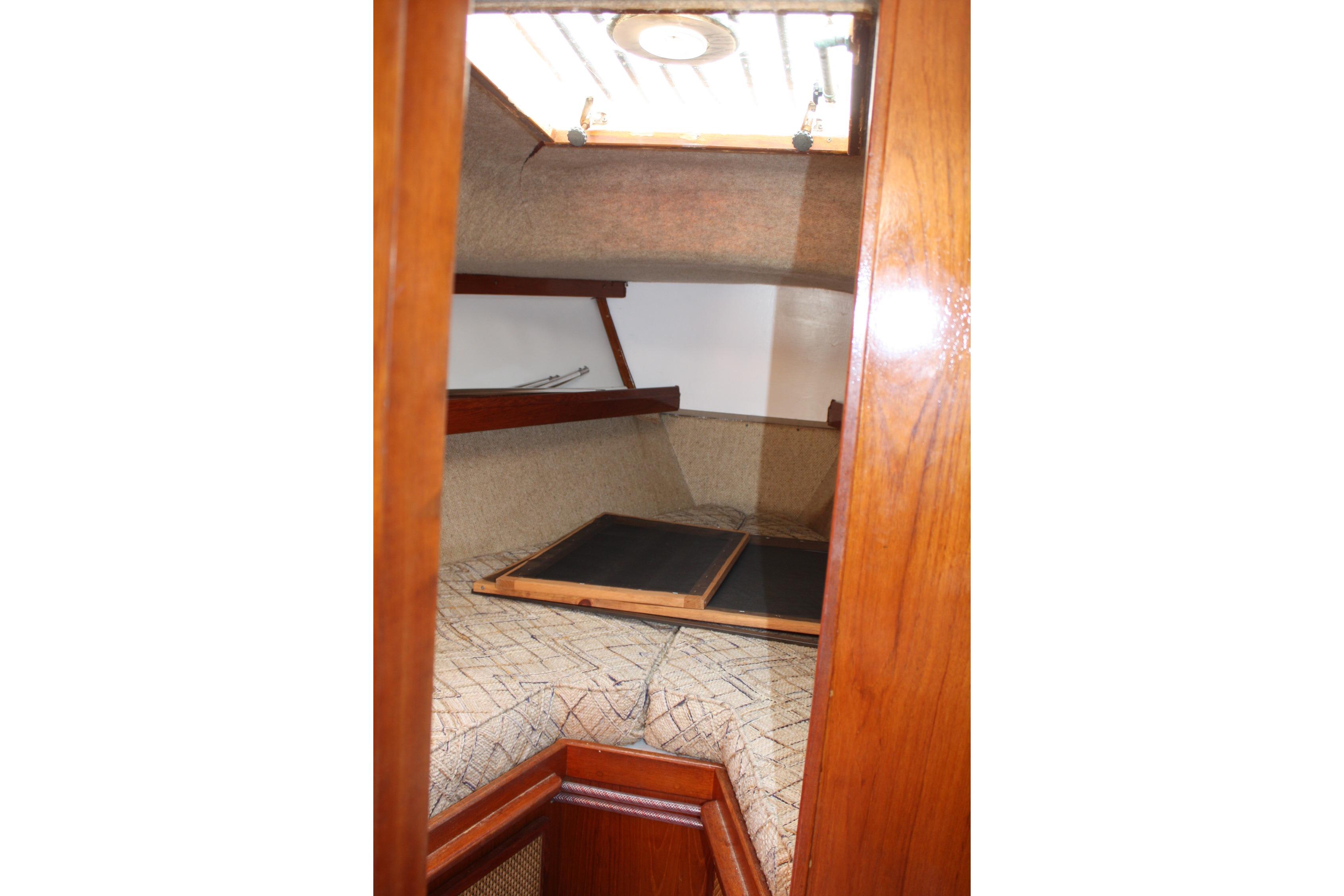 Interior cabin of a 1981 S2 9.2A sailboat with wooden trim and cozy sleeping area.