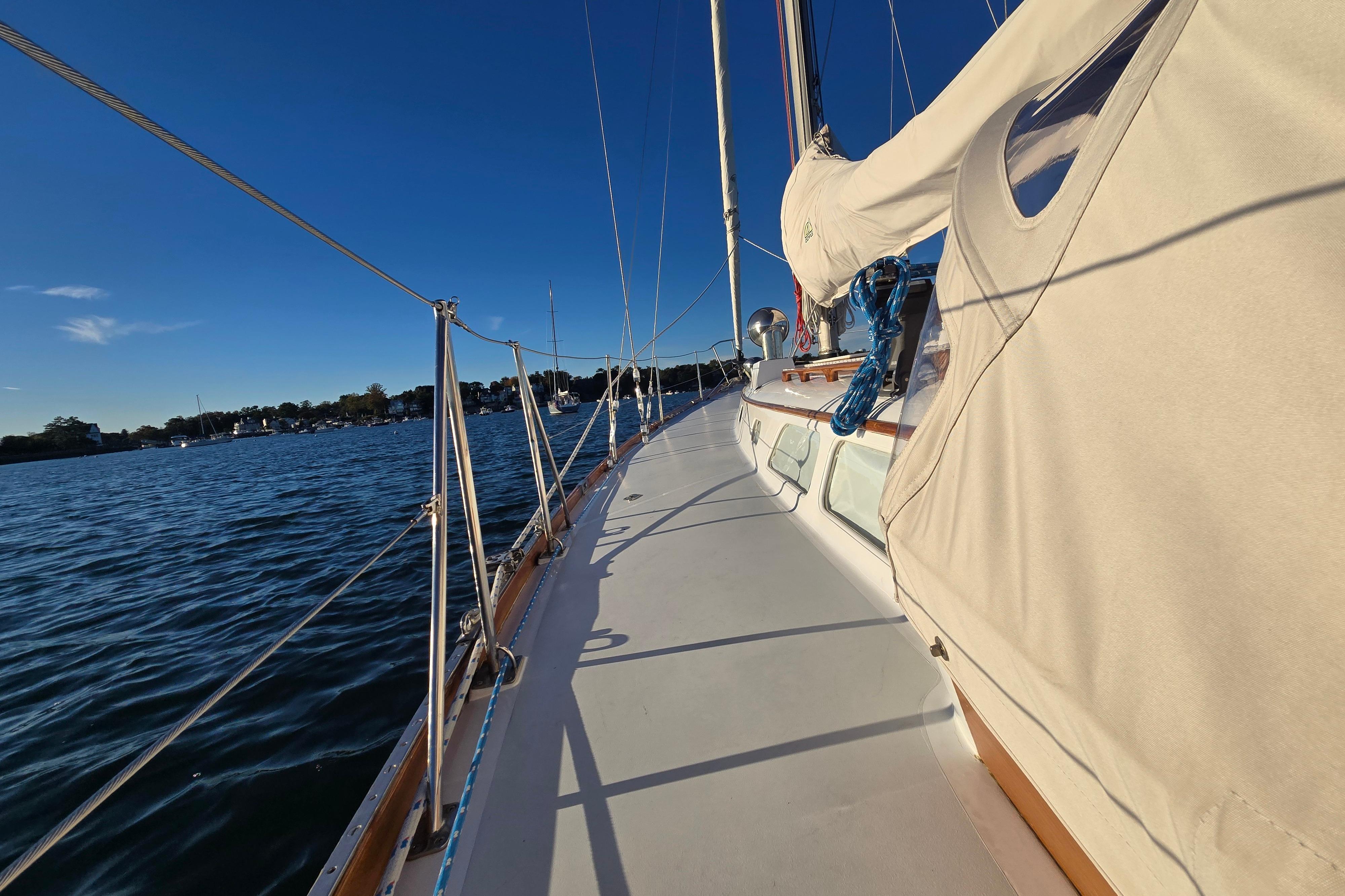1970 Hinckley Bermuda 40 sailboat deck with clear blue sky and calm waters.