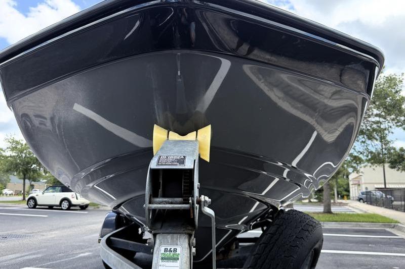 2017 Yamaha Boats SX210 on trailer, parked in a lot, viewed from the front.