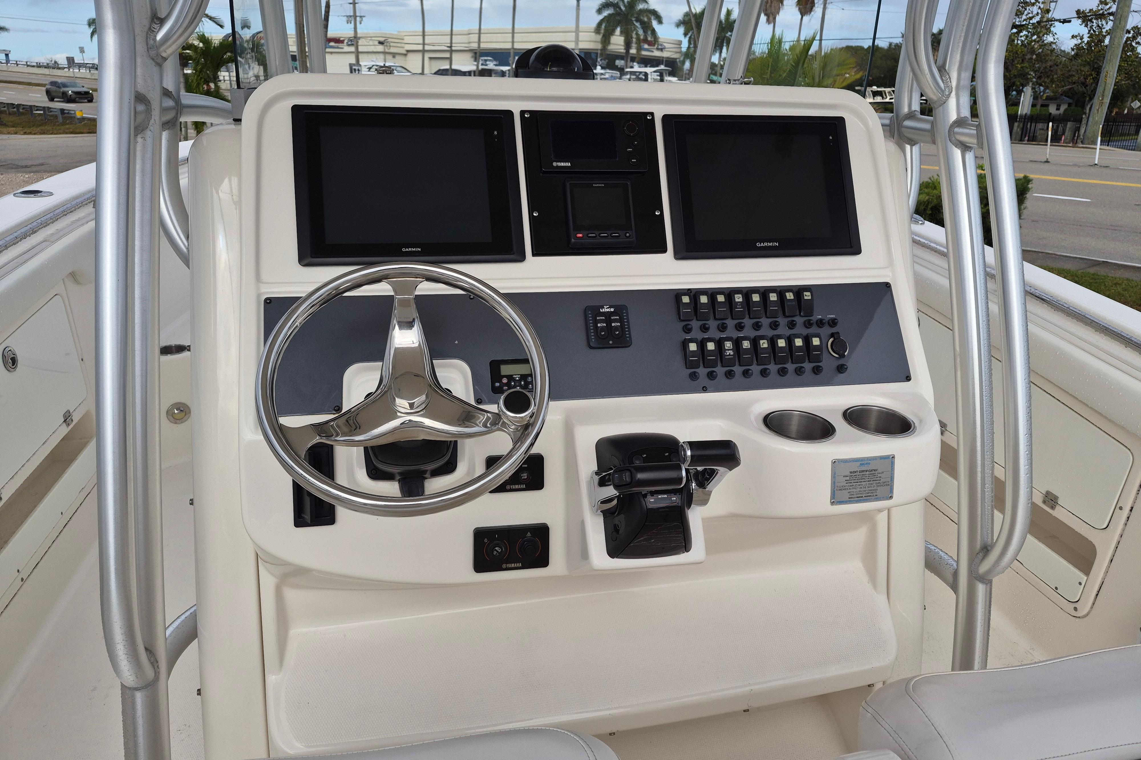 2014 Robalo R300 Center Console boat dashboard with steering wheel and control panel.