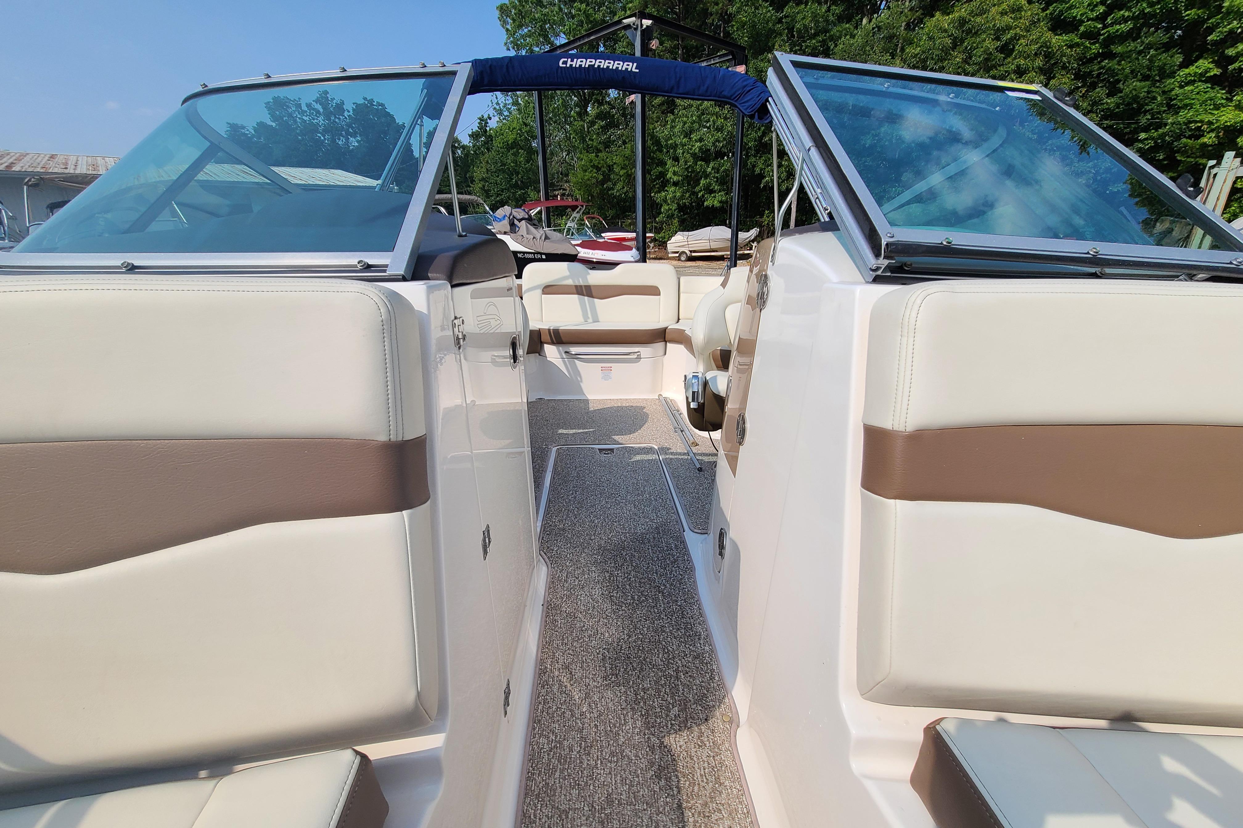 2014 Chaparral 246 SSi boat interior with beige and brown seating, open windshield.