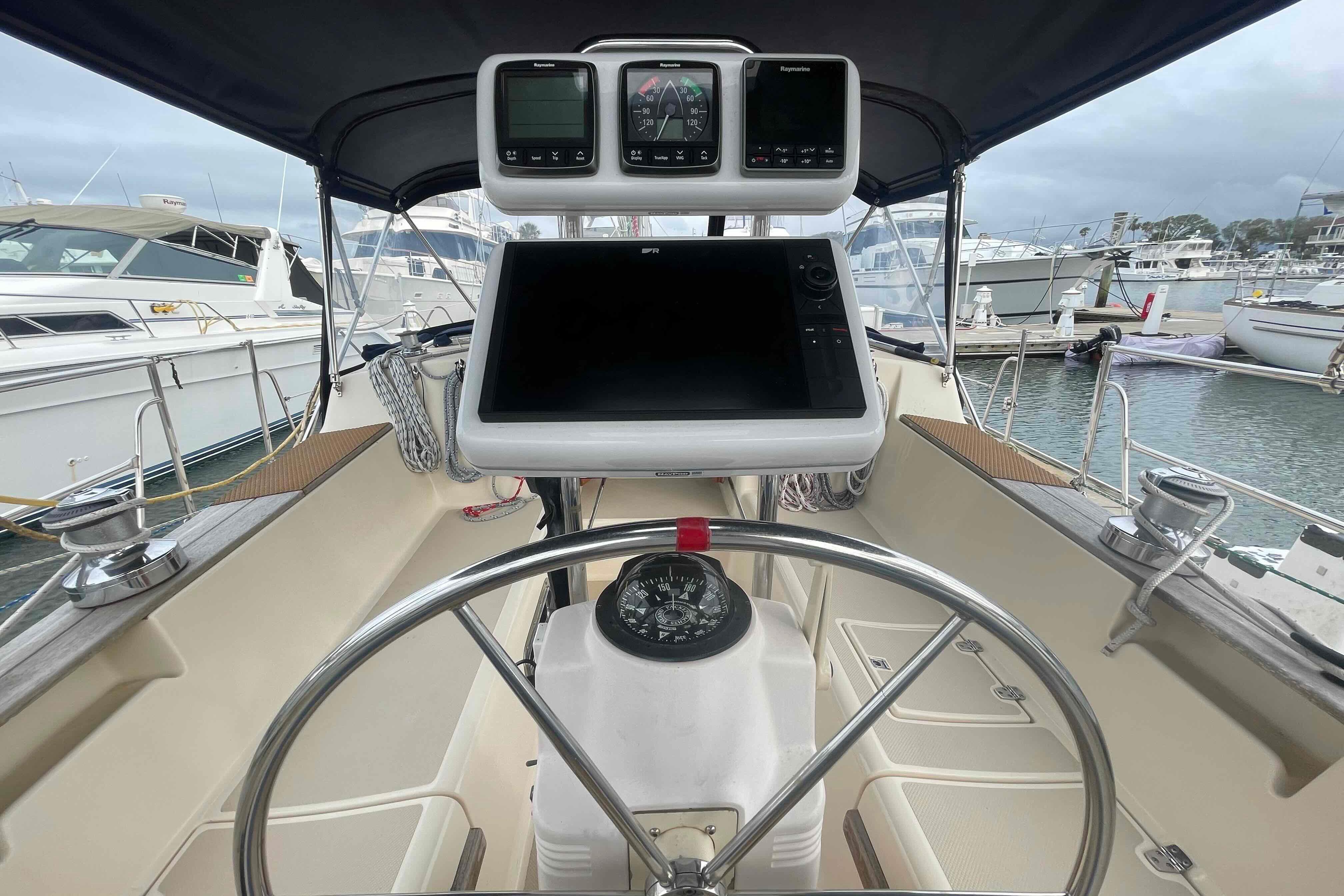 Cockpit of 1998 Island Packet 40 sailboat with navigation instruments and steering wheel.